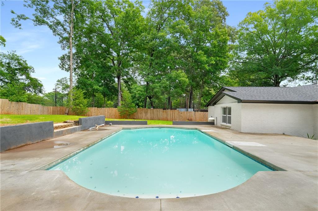 3154 North Druid Hills Road Northeast Decatur, GA 30033 - Photo 19 of 82 a view of a swimming pool with a yard and large trees