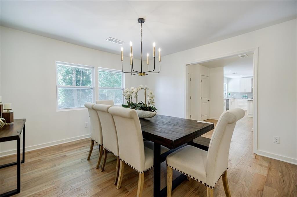 3154 North Druid Hills Road Northeast Decatur, GA 30033 - Photo 28 of 82 a view of a dining room with furniture a chandelier and wooden floor