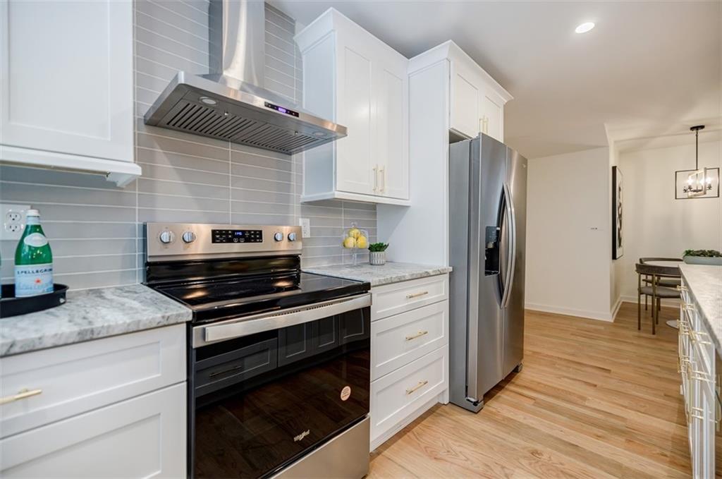 3154 North Druid Hills Road Northeast Decatur, GA 30033 - Photo 43 of 82 a kitchen with a refrigerator stove and cabinets