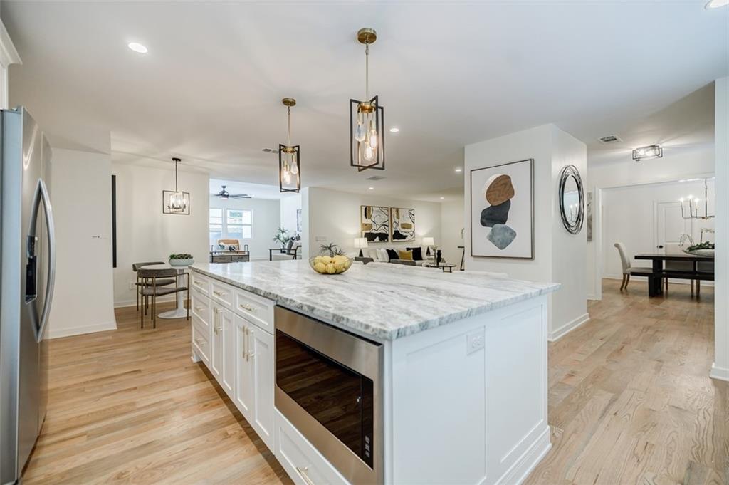 3154 North Druid Hills Road Northeast Decatur, GA 30033 - Photo 44 of 82 a kitchen with stainless steel appliances granite countertop wooden floors and sink