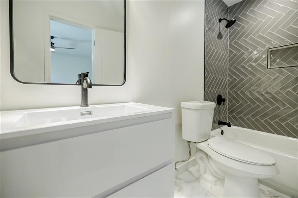 3154 North Druid Hills Road Northeast Decatur, GA 30033 - Photo 54 of 82 a bathroom with a sink a toilet and shower