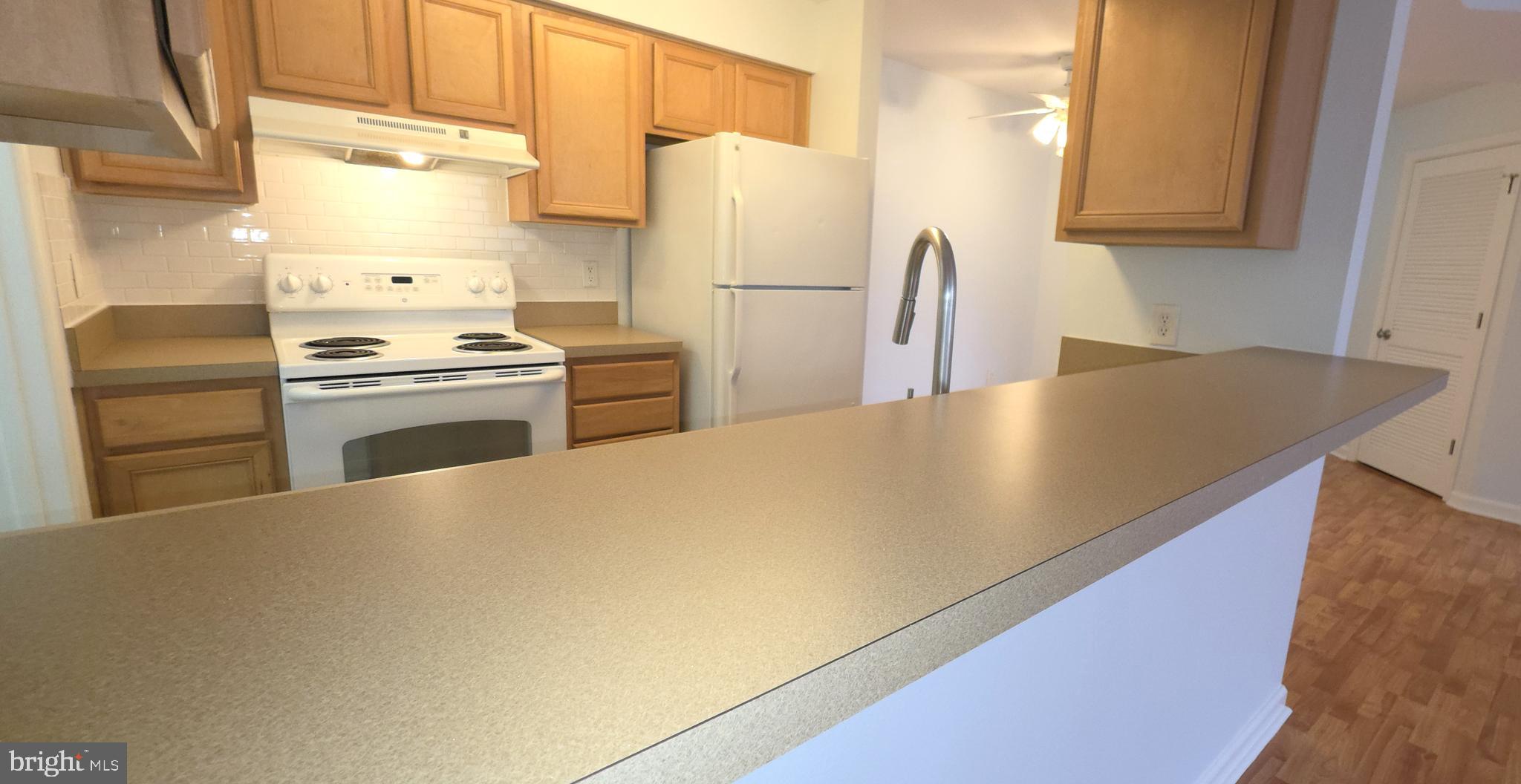 11228 Torrie Way, Unit G Bealeton, VA 22712 - Photo 12 of 30 a kitchen with refrigerator a stove a sink and a cabinets