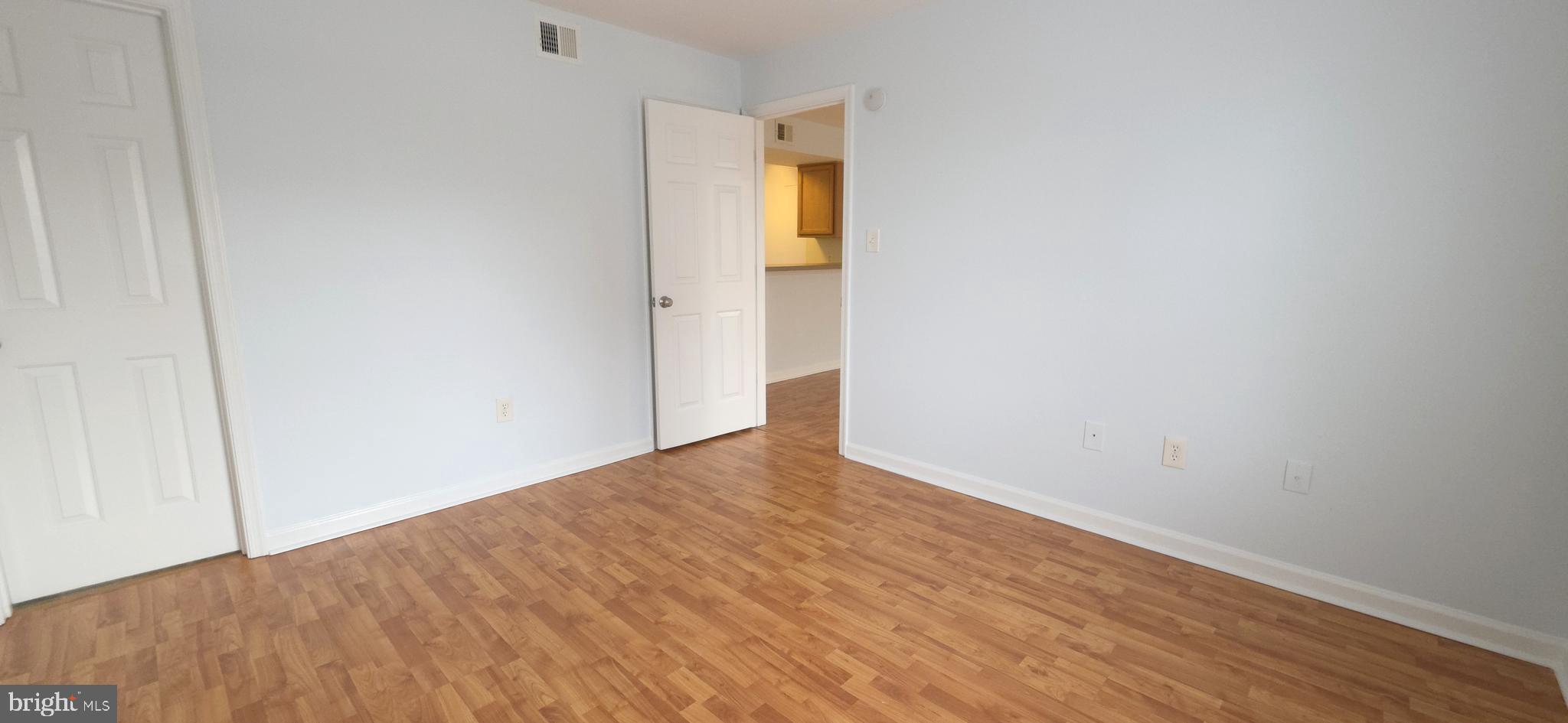 11228 Torrie Way, Unit G Bealeton, VA 22712 - Photo 16 of 30 a view of an empty room with wooden floor and a window