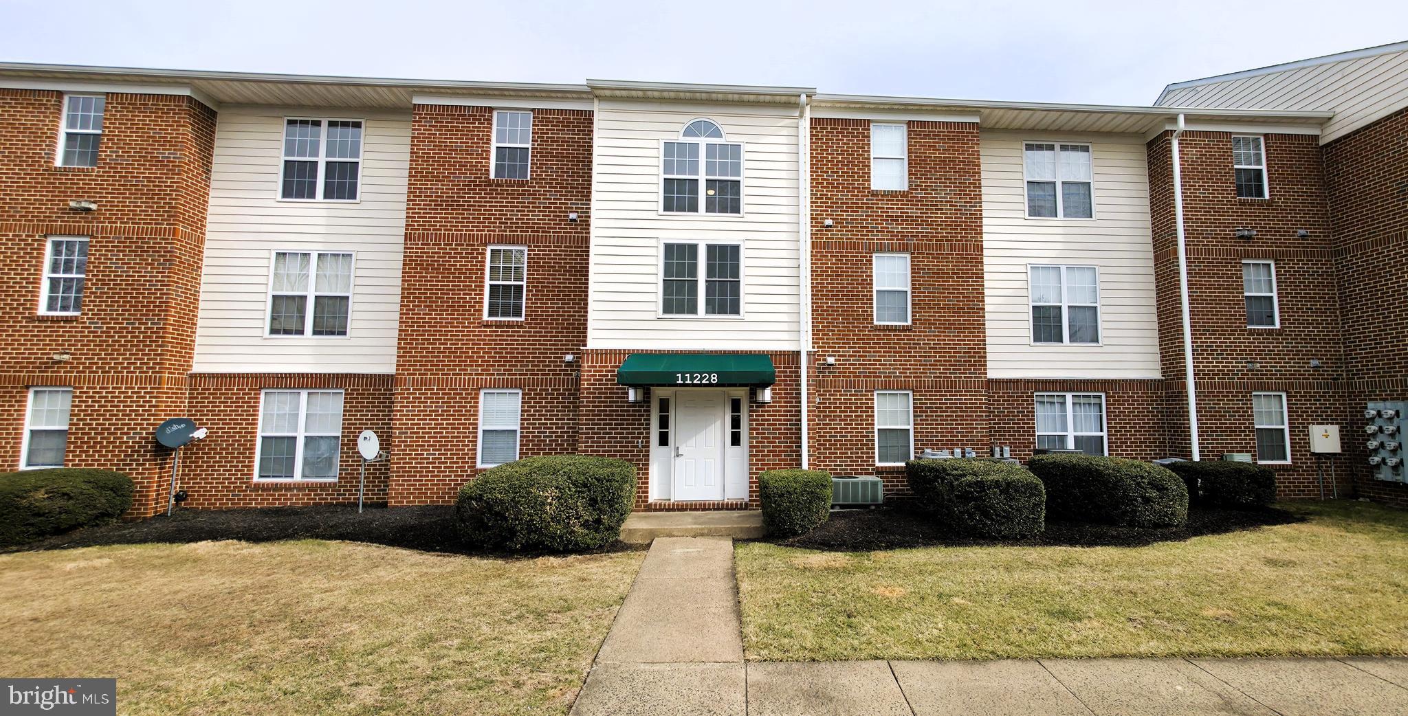11228 Torrie Way, Unit G Bealeton, VA 22712 - Photo 2 of 30 a view of a brick building with many windows