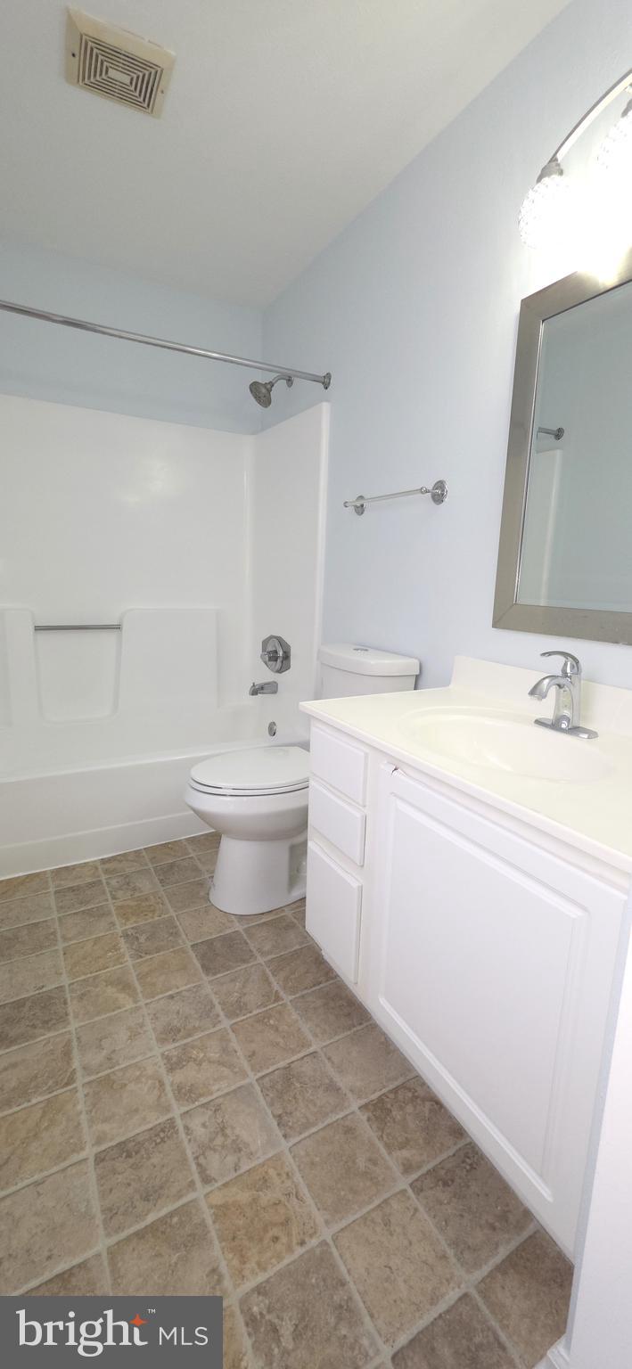 11228 Torrie Way, Unit G Bealeton, VA 22712 - Photo 21 of 30 a bathroom with a sink a toilet and a mirror