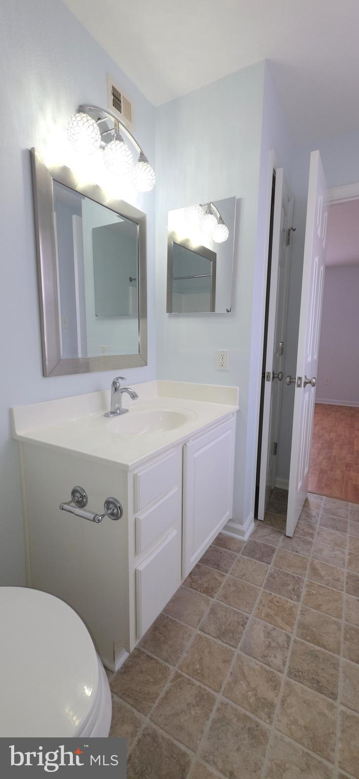 11228 Torrie Way, Unit G Bealeton, VA 22712 - Photo 22 of 30 a bathroom with a sink a toilet and mirror