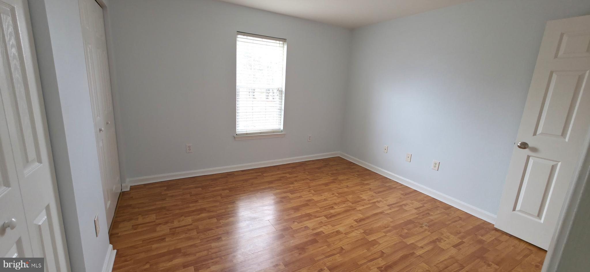 11228 Torrie Way, Unit G Bealeton, VA 22712 - Photo 24 of 30 an empty room with wooden floor and windows
