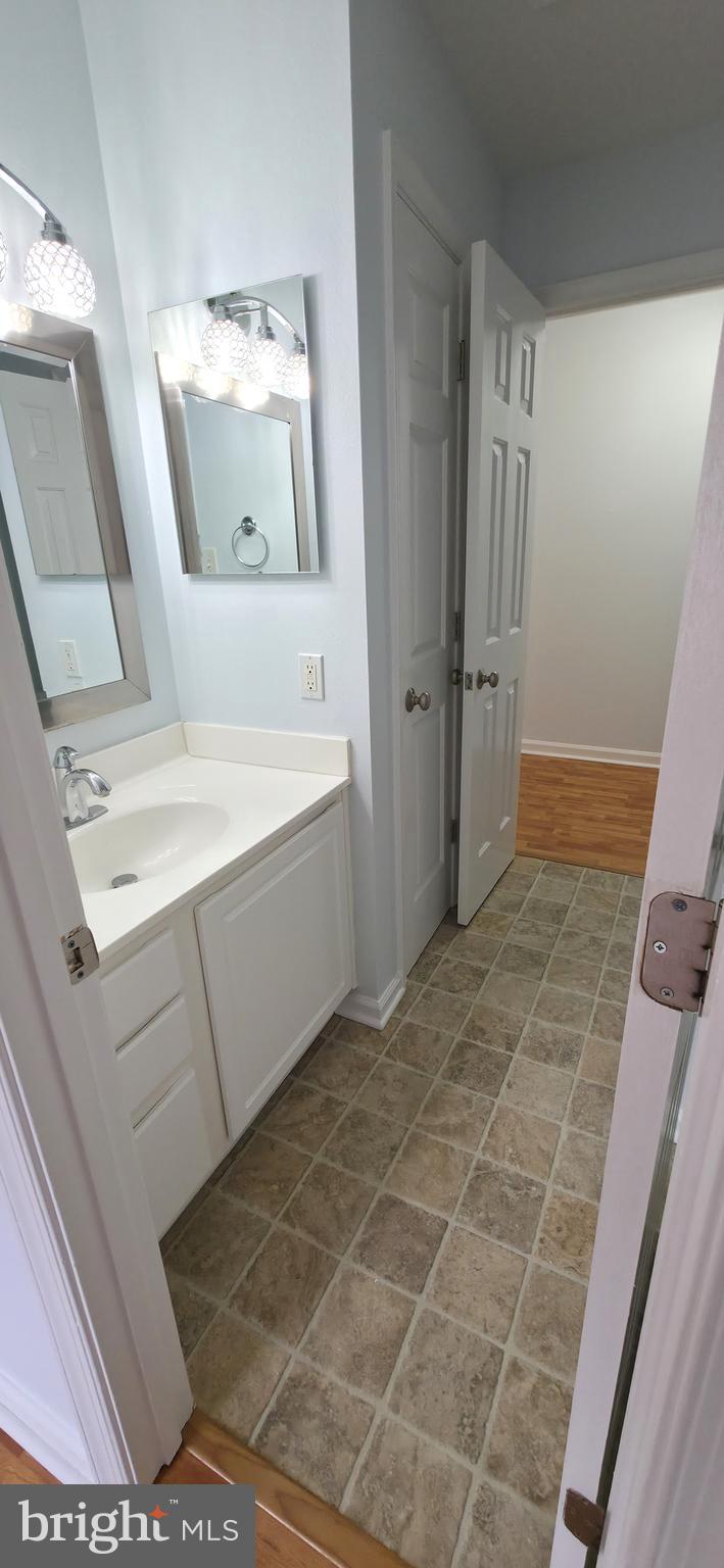 11228 Torrie Way, Unit G Bealeton, VA 22712 - Photo 26 of 30 a bathroom with a sink a toilet and mirror