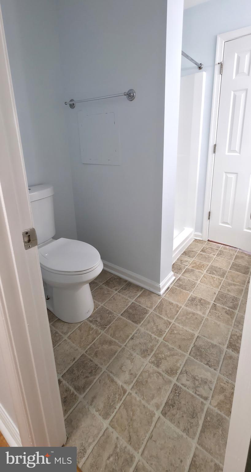 11228 Torrie Way, Unit G Bealeton, VA 22712 - Photo 27 of 30 a bathroom with a toilet and a shower