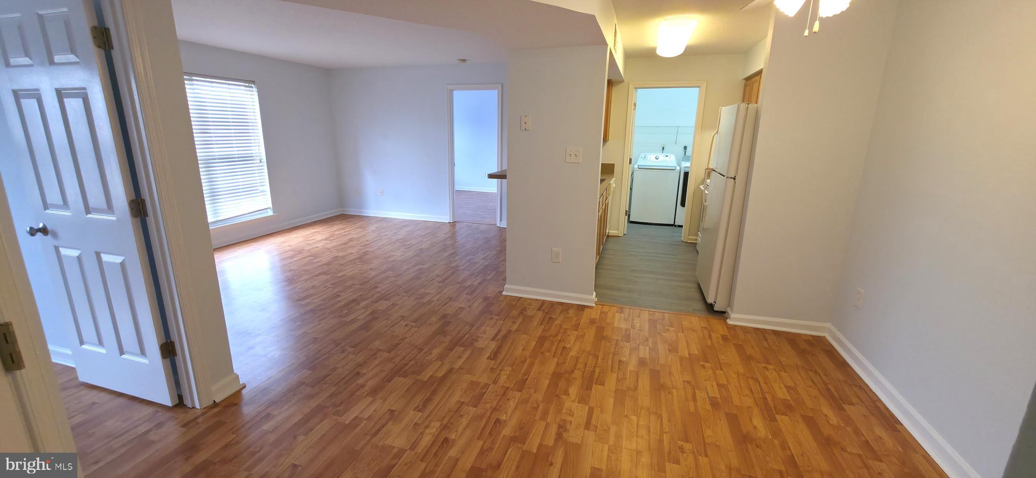 11228 Torrie Way, Unit G Bealeton, VA 22712 - Photo 9 of 30 wooden floor in an empty room with a mirror