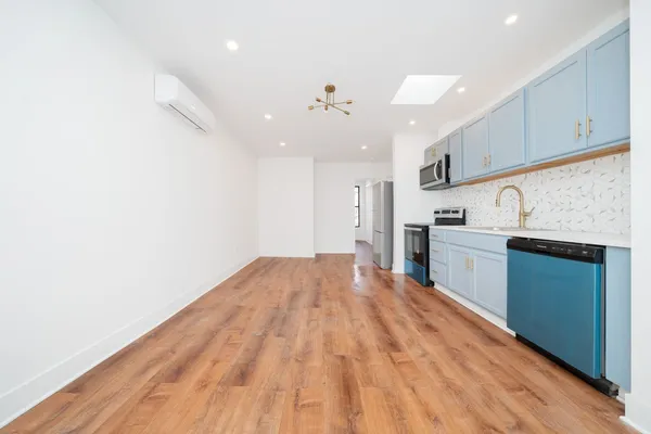 a view of kitchen with granite countertop cabinets and stainless steel appliances