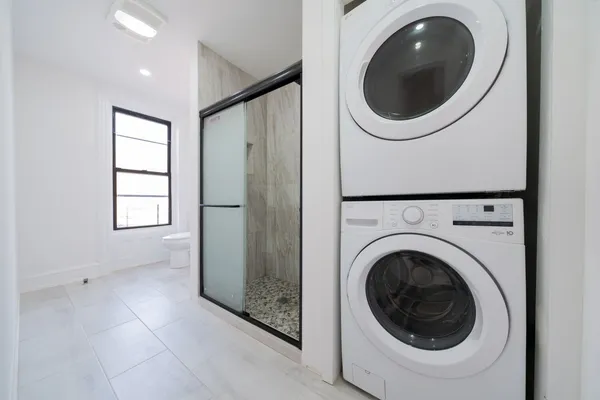 a view of a hallway with washer and dryer