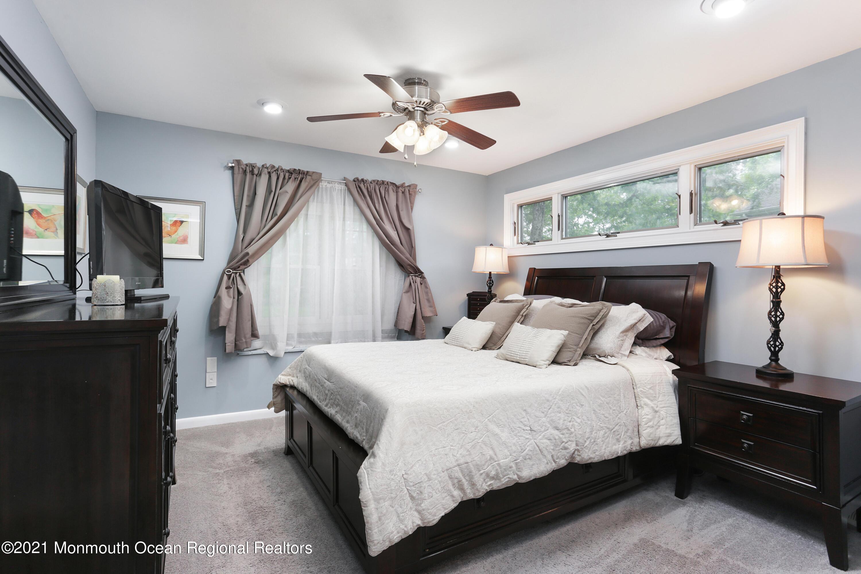 719 Gail Chambers Road Jackson, NJ 08527 - Photo 18 of 34 a bedroom with a bed and a flat tv screen on dresser