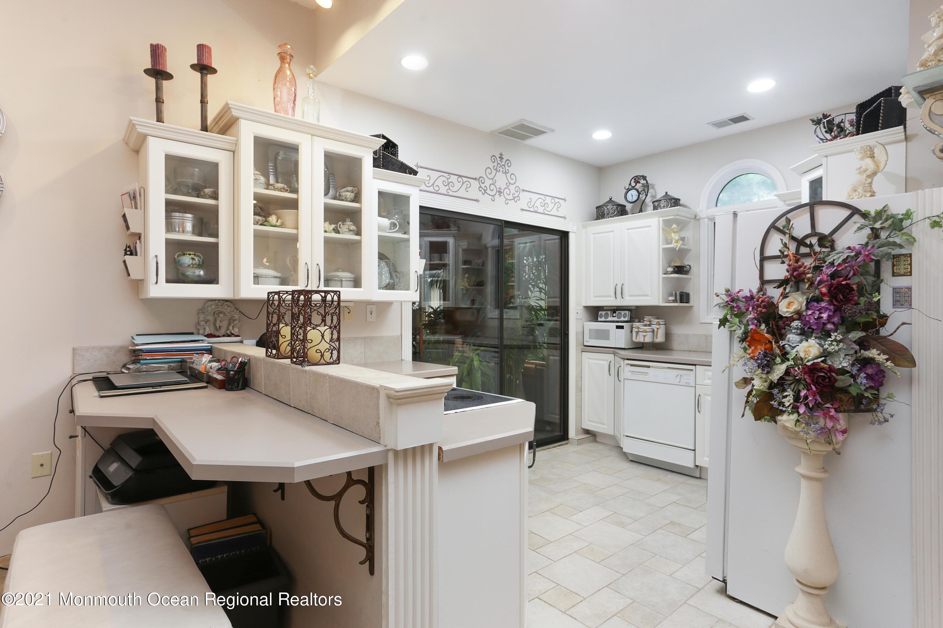 719 Gail Chambers Road Jackson, NJ 08527 - Photo 23 of 34 a kitchen with stainless steel appliances a sink a table and chairs