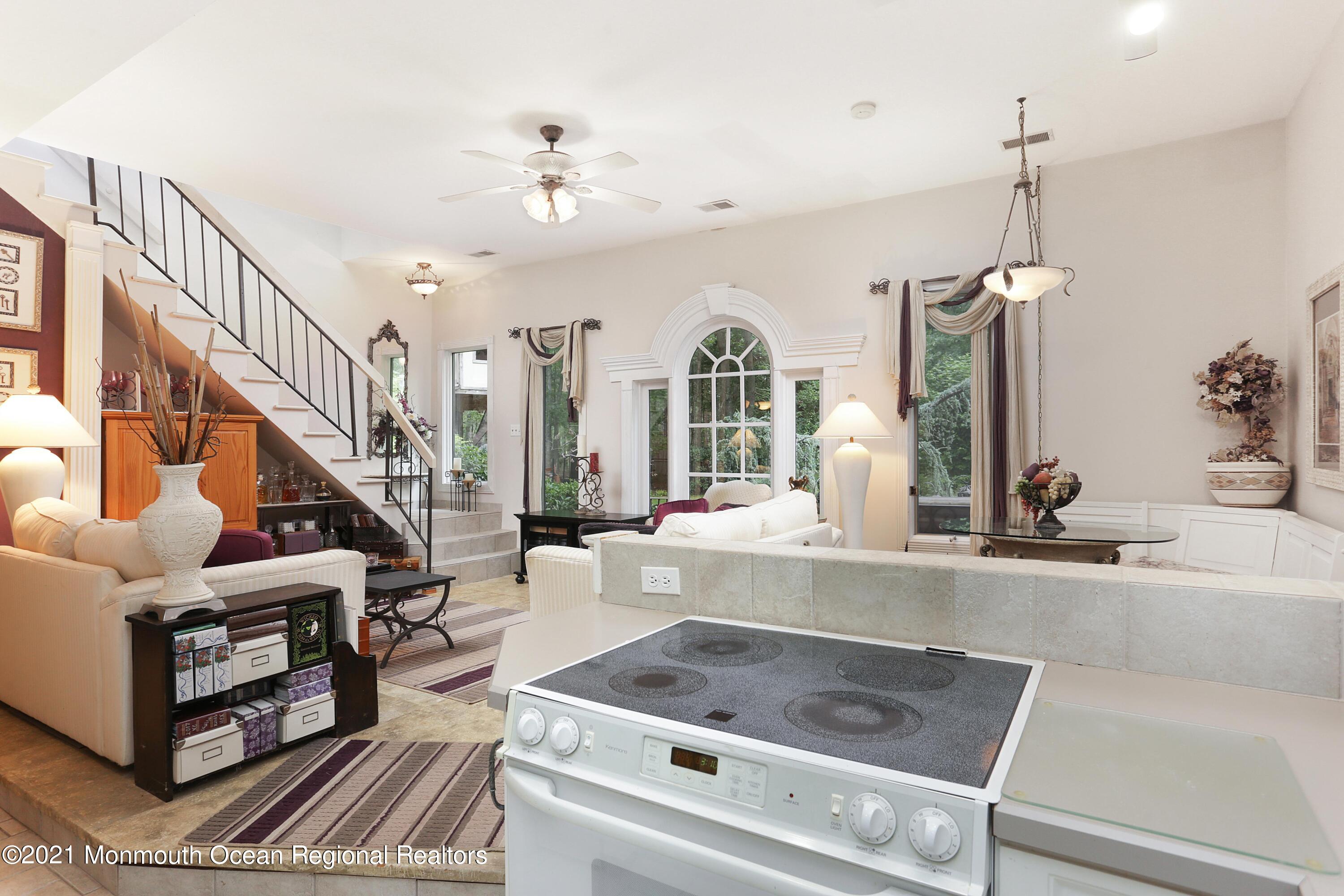 719 Gail Chambers Road Jackson, NJ 08527 - Photo 24 of 34 a living room with furniture and a chandelier