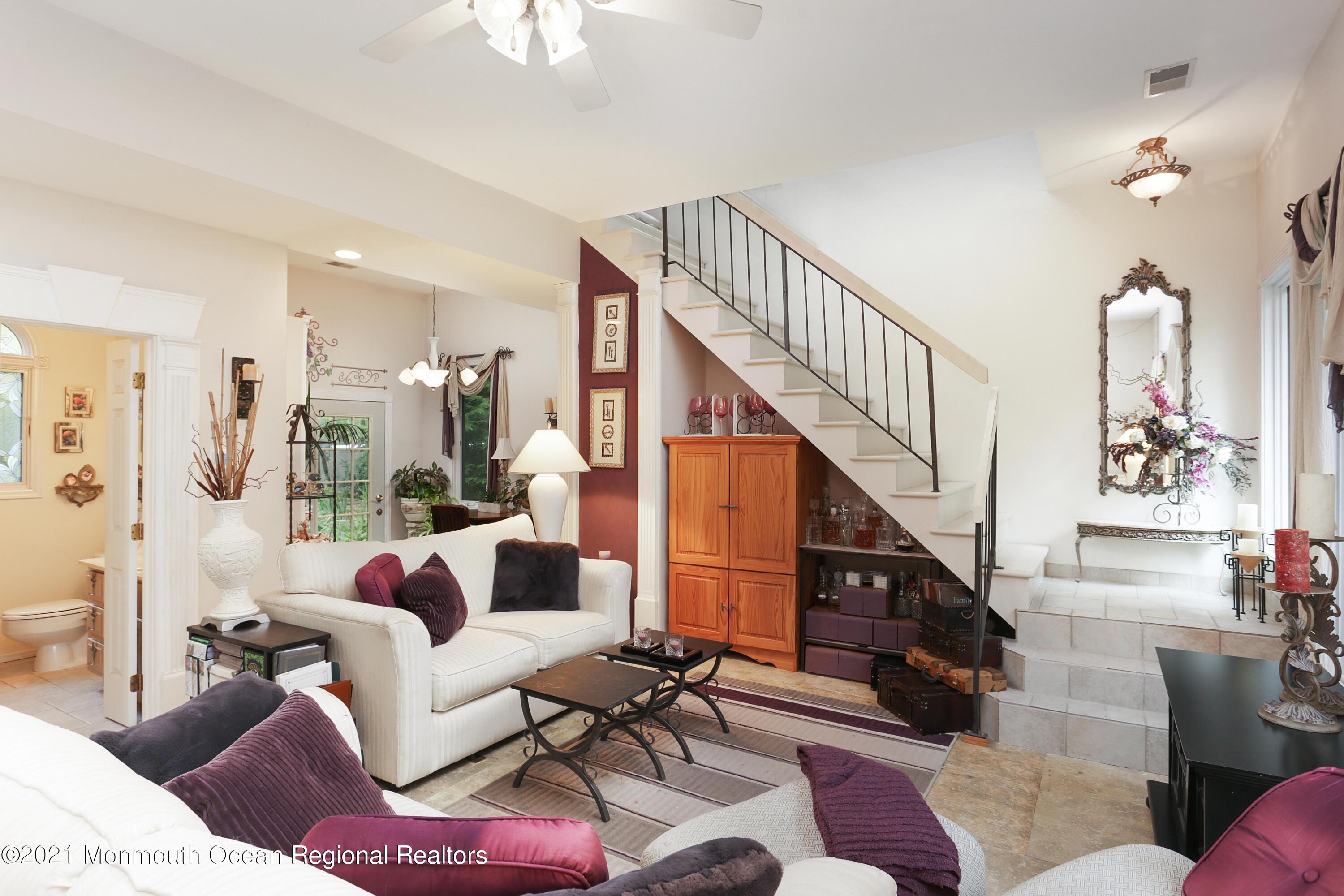 719 Gail Chambers Road Jackson, NJ 08527 - Photo 25 of 34 a living room with furniture and a chandelier