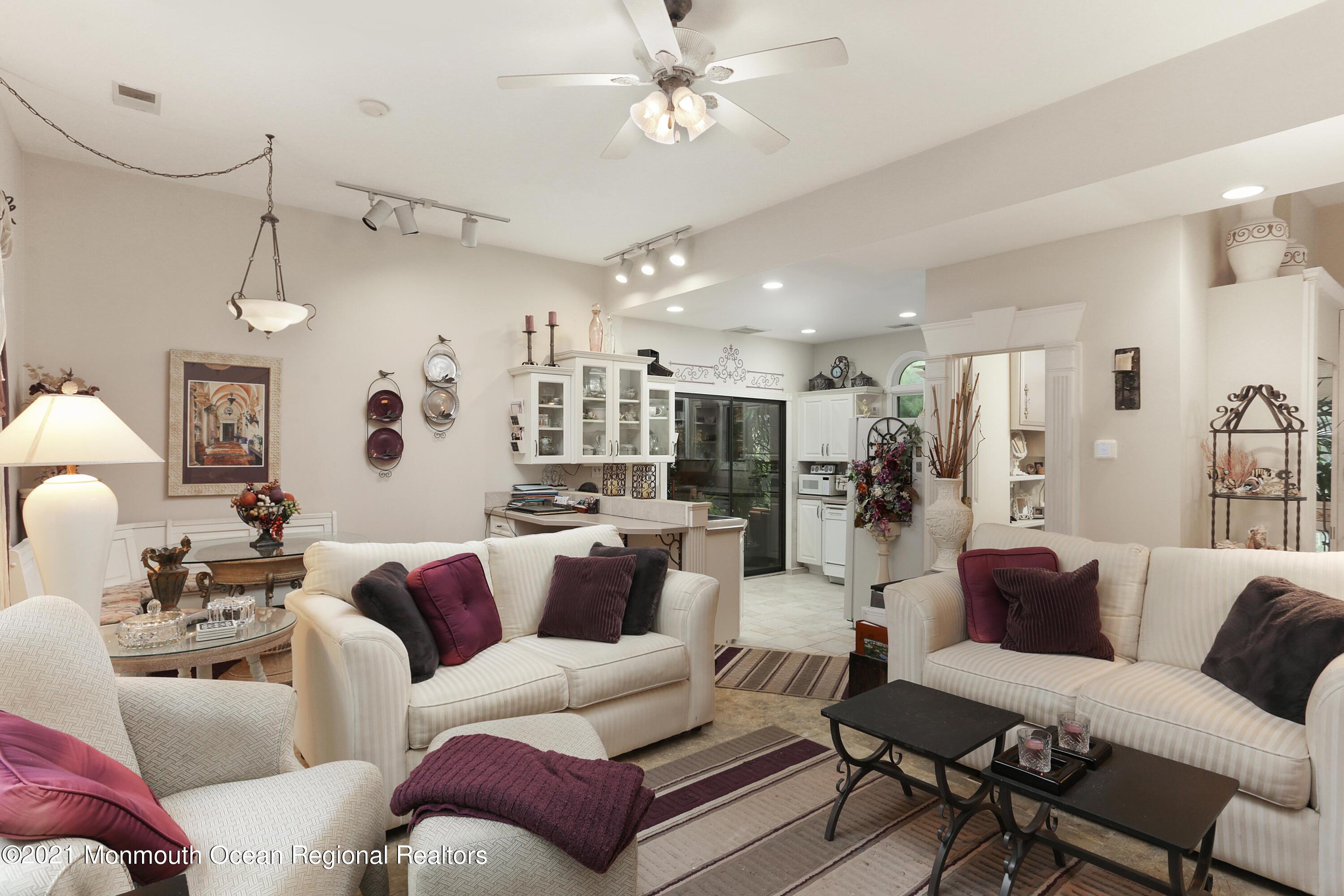 719 Gail Chambers Road Jackson, NJ 08527 - Photo 26 of 34 a living room with furniture kitchen view and a chandelier