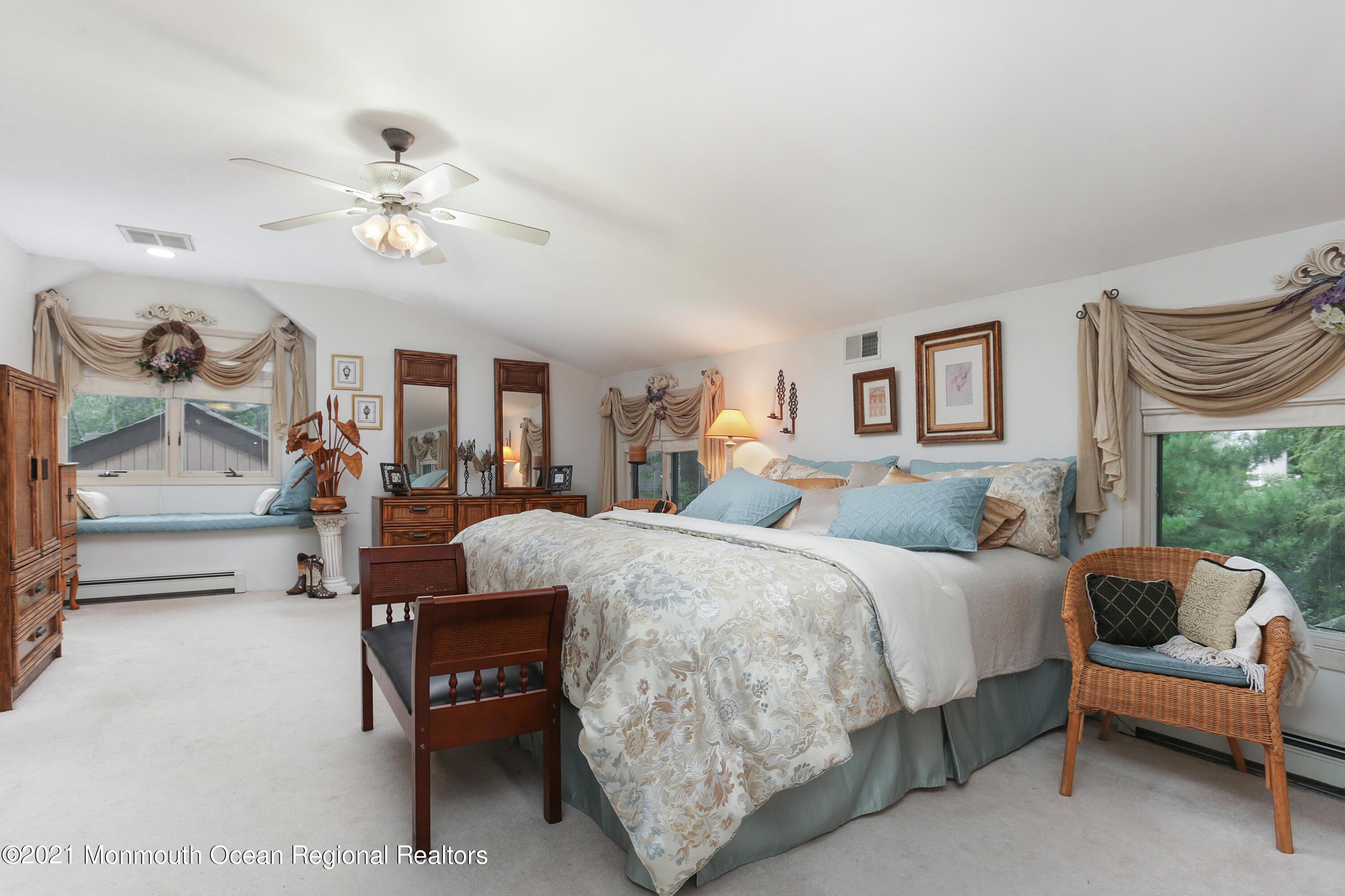 719 Gail Chambers Road Jackson, NJ 08527 - Photo 27 of 34 a bed room with a bed and a chandelier