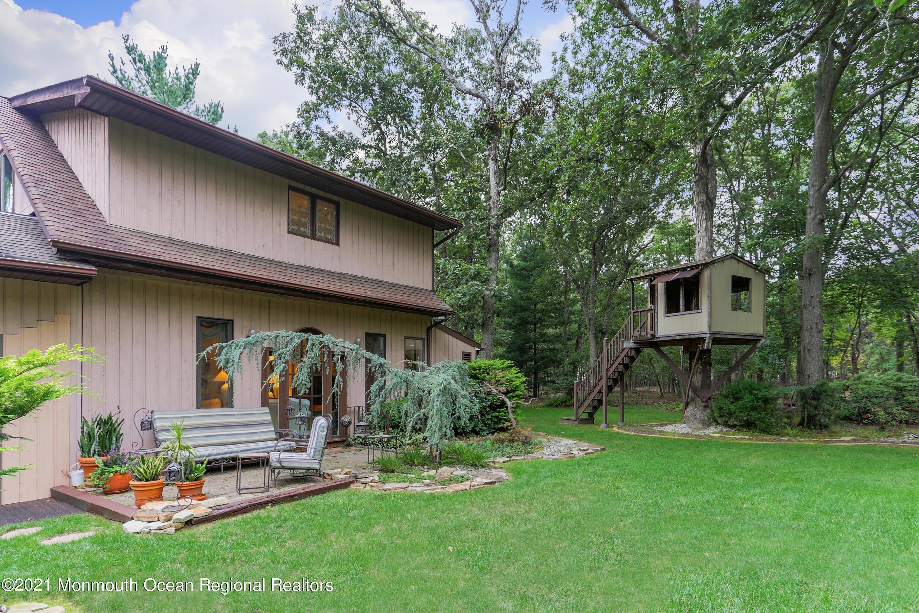 719 Gail Chambers Road Jackson, NJ 08527 - Photo 29 of 34 a front view of a house with a garden and plants
