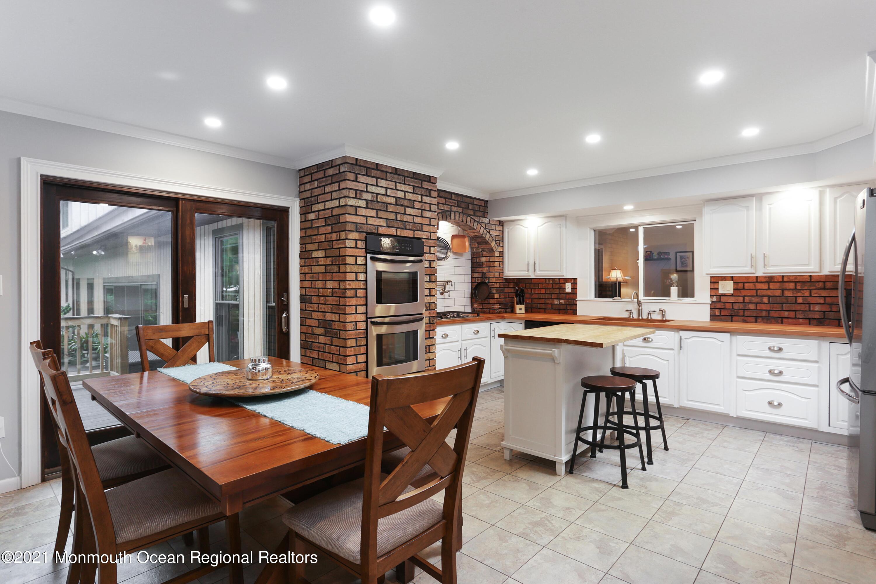 719 Gail Chambers Road Jackson, NJ 08527 - Photo 6 of 34 a kitchen with a table chairs and a refrigerator