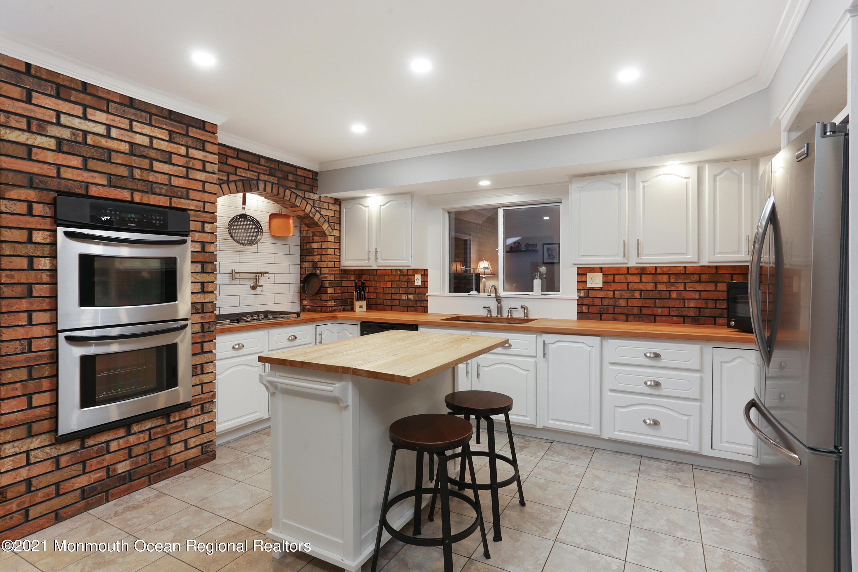 719 Gail Chambers Road Jackson, NJ 08527 - Photo 7 of 34 a kitchen with counter top space cabinets and stainless steel appliances