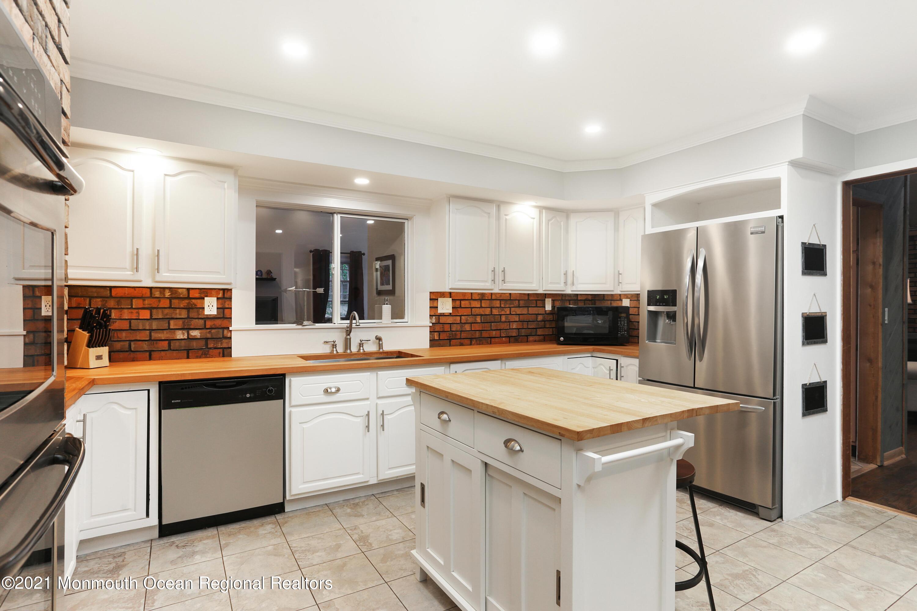 719 Gail Chambers Road Jackson, NJ 08527 - Photo 8 of 34 a kitchen with a sink refrigerator and cabinets