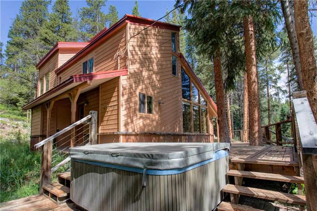 224 Spruce Creek Road Breckenridge, CO 80424 - Photo 6 of 21 a view of house with wooden fence and large trees
