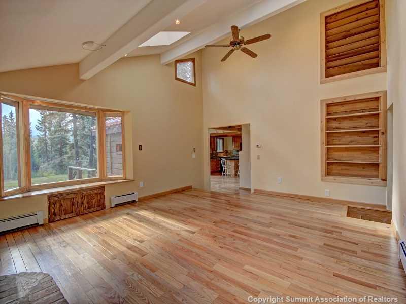 224 Spruce Creek Road Breckenridge, CO 80424 - Photo 10 of 21 a view of an empty room with a window and wooden floor
