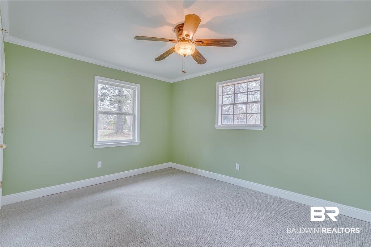 440 Dykes Road Mobile, AL 36608 - Photo 22 of 49 Carpeted spare room with a healthy amount of sunlight, baseboards, and ornamental molding