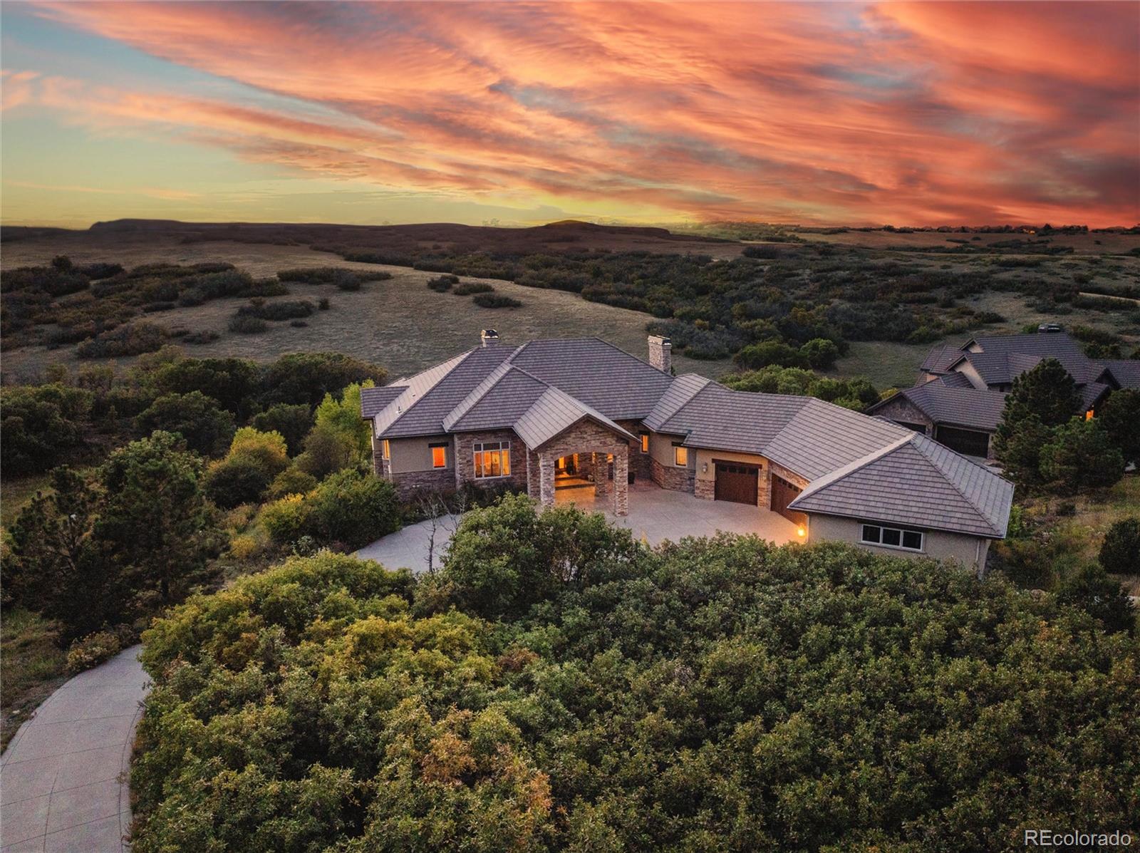 a view of a big house with a big yard and large tree