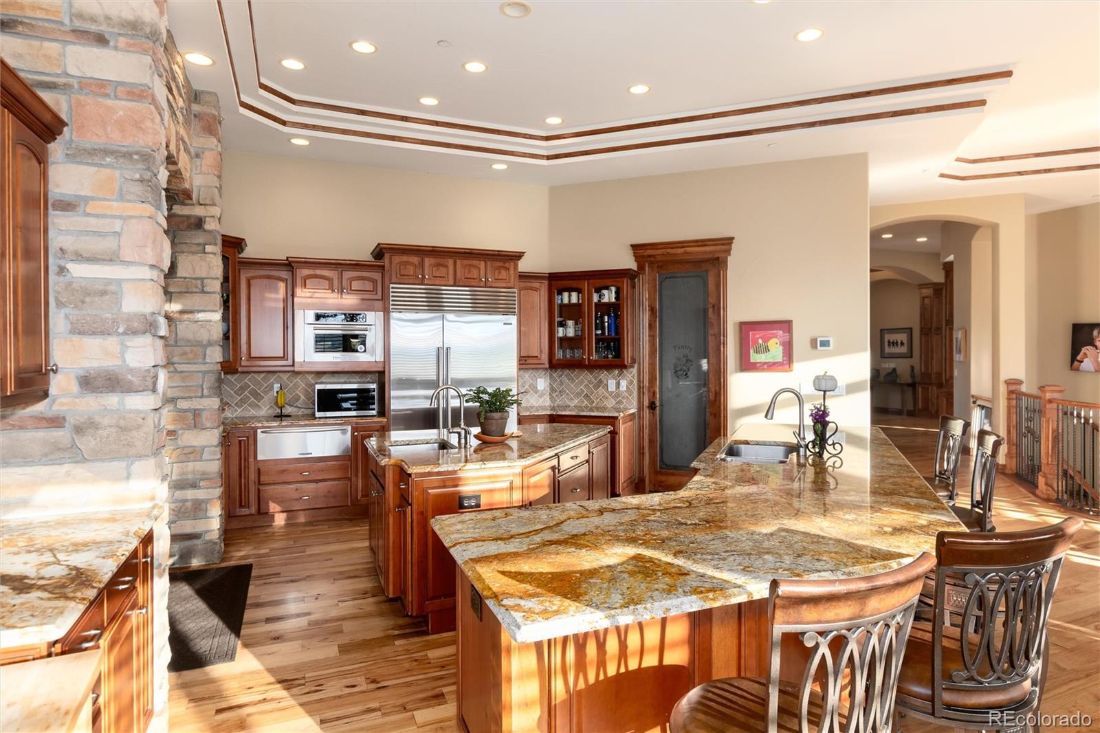 13079 Whisper Canyon Road Castle Pines, CO 80108 - Photo 16 of 50 a dining table and chairs in a room with kitchen view