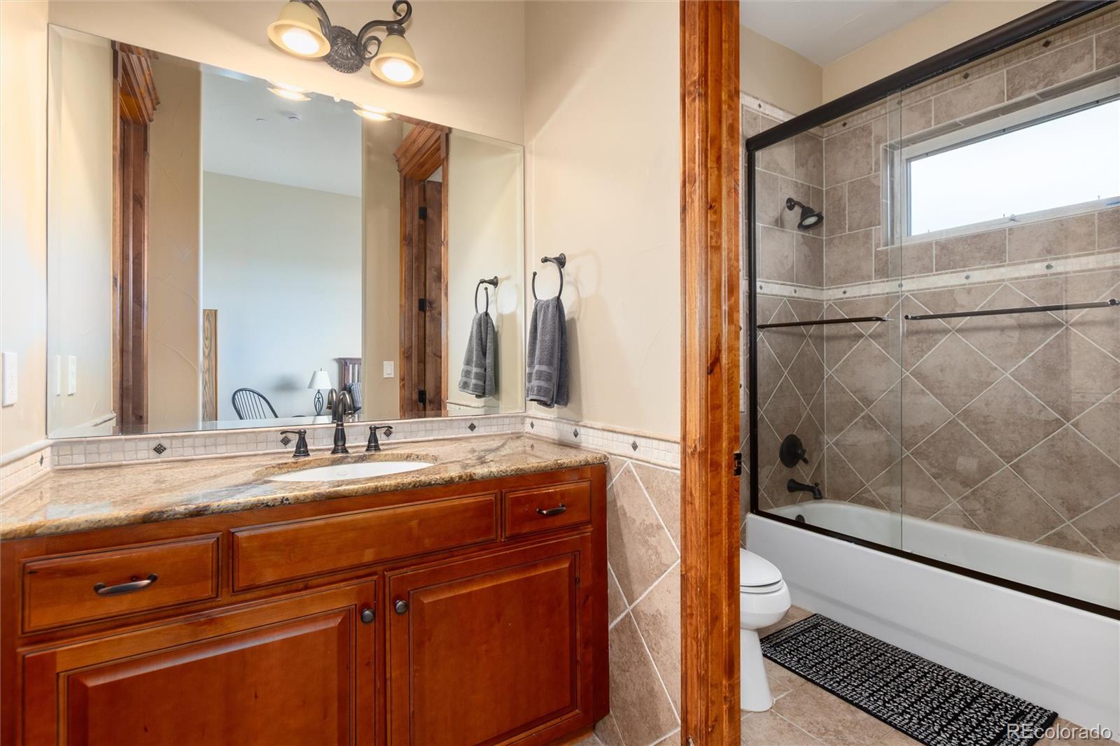 13079 Whisper Canyon Road Castle Pines, CO 80108 - Photo 25 of 50 a bathroom with a double vanity sink mirror and double