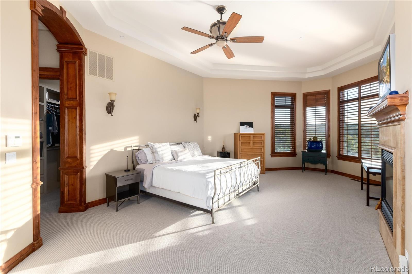 13079 Whisper Canyon Road Castle Pines, CO 80108 - Photo 27 of 50 a bedroom with a bed couch and a window