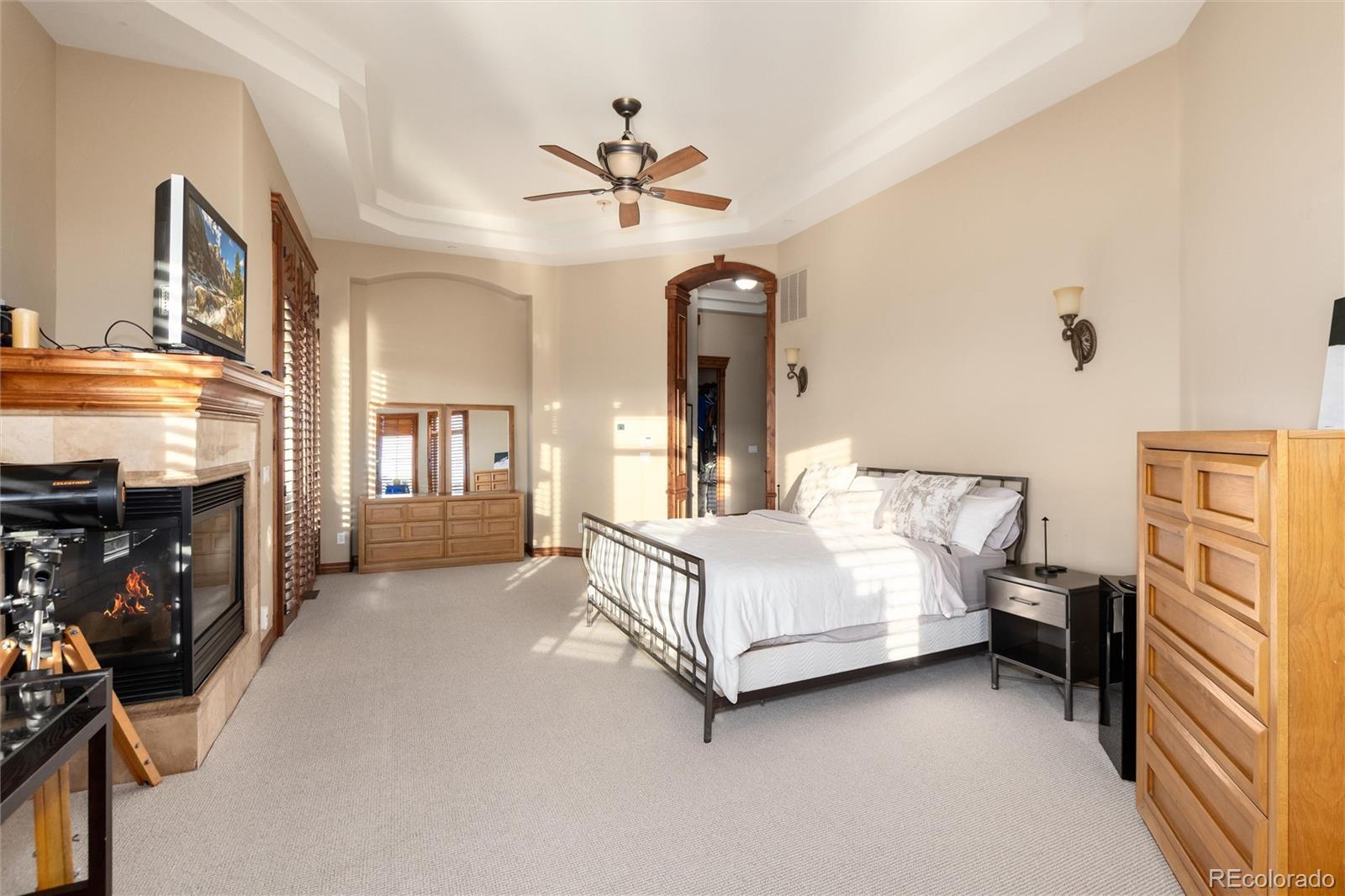 13079 Whisper Canyon Road Castle Pines, CO 80108 - Photo 28 of 50 a room with a bed and a chandelier