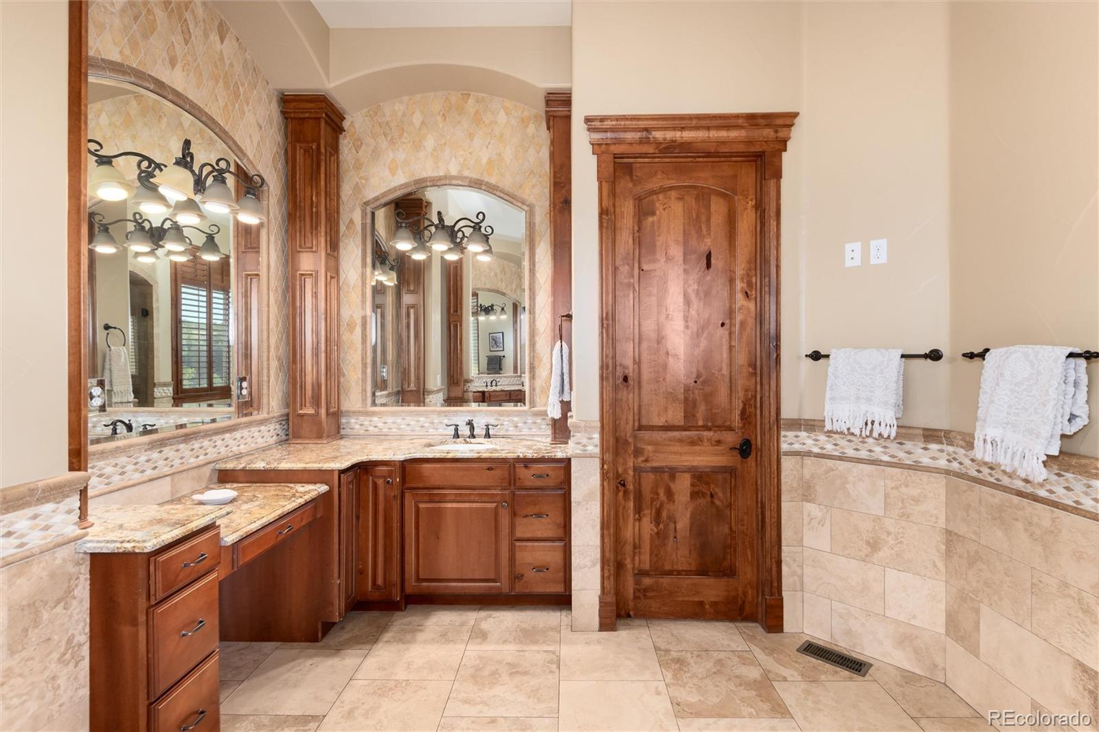13079 Whisper Canyon Road Castle Pines, CO 80108 - Photo 29 of 50 a large bathroom with a sink and a mirror