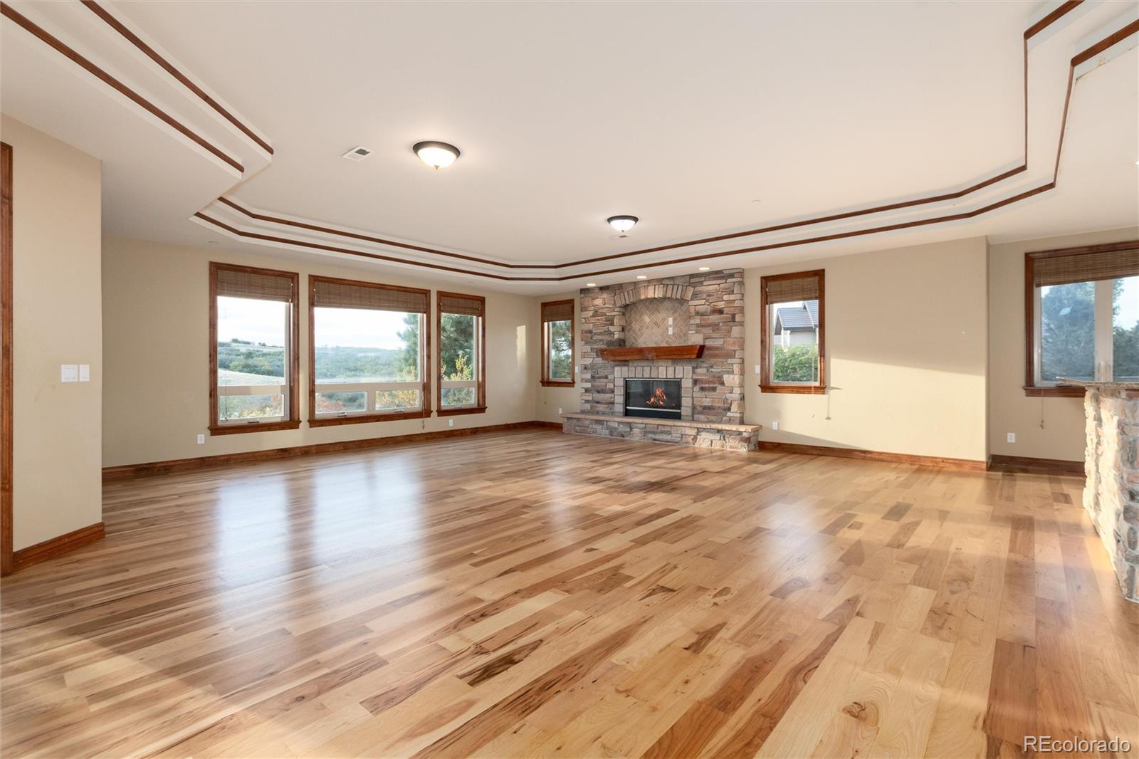 13079 Whisper Canyon Road Castle Pines, CO 80108 - Photo 32 of 50 a view of empty room with wooden floor and fan