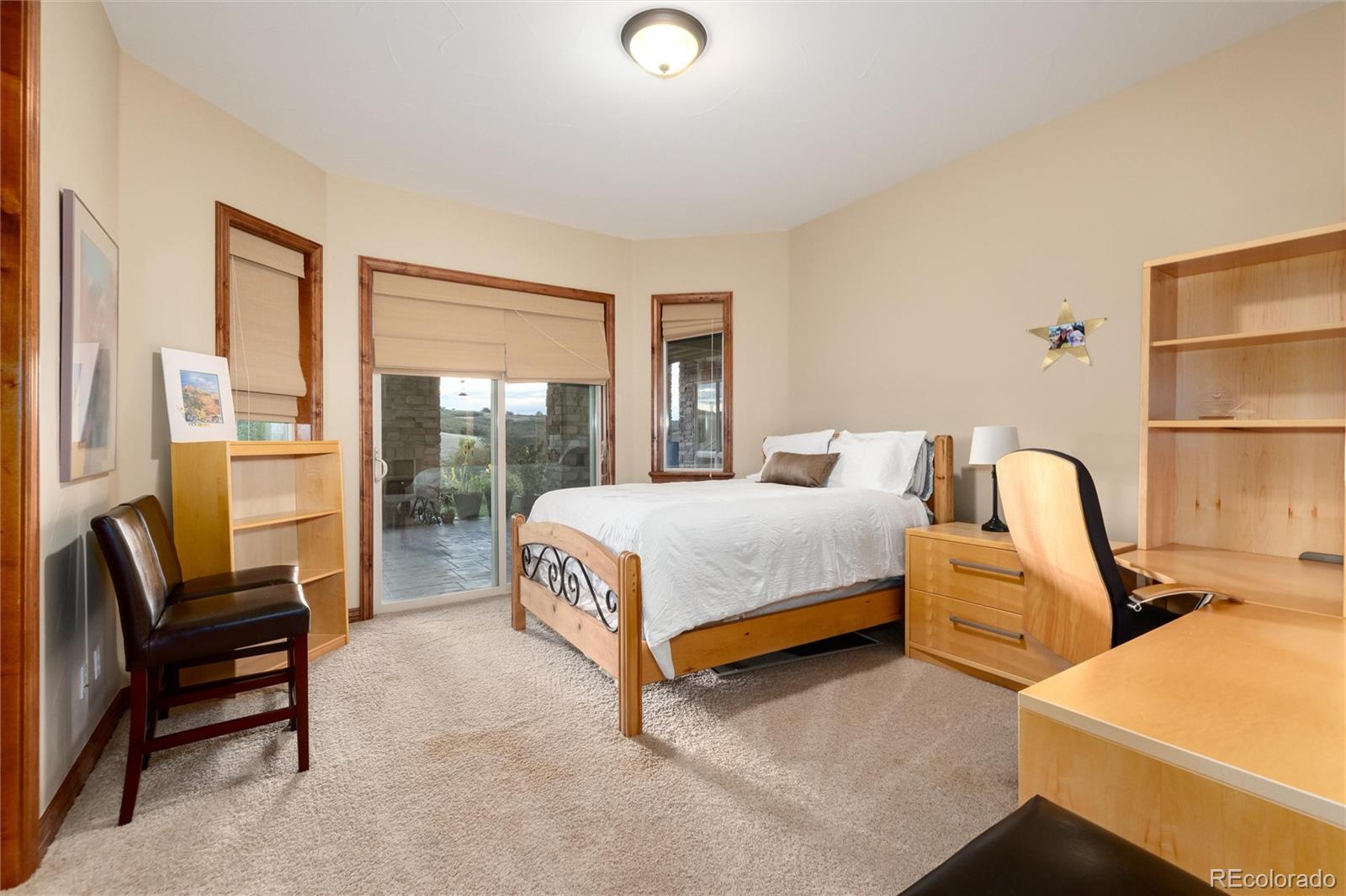 13079 Whisper Canyon Road Castle Pines, CO 80108 - Photo 39 of 50 a bed sitting in a bedroom next to a window