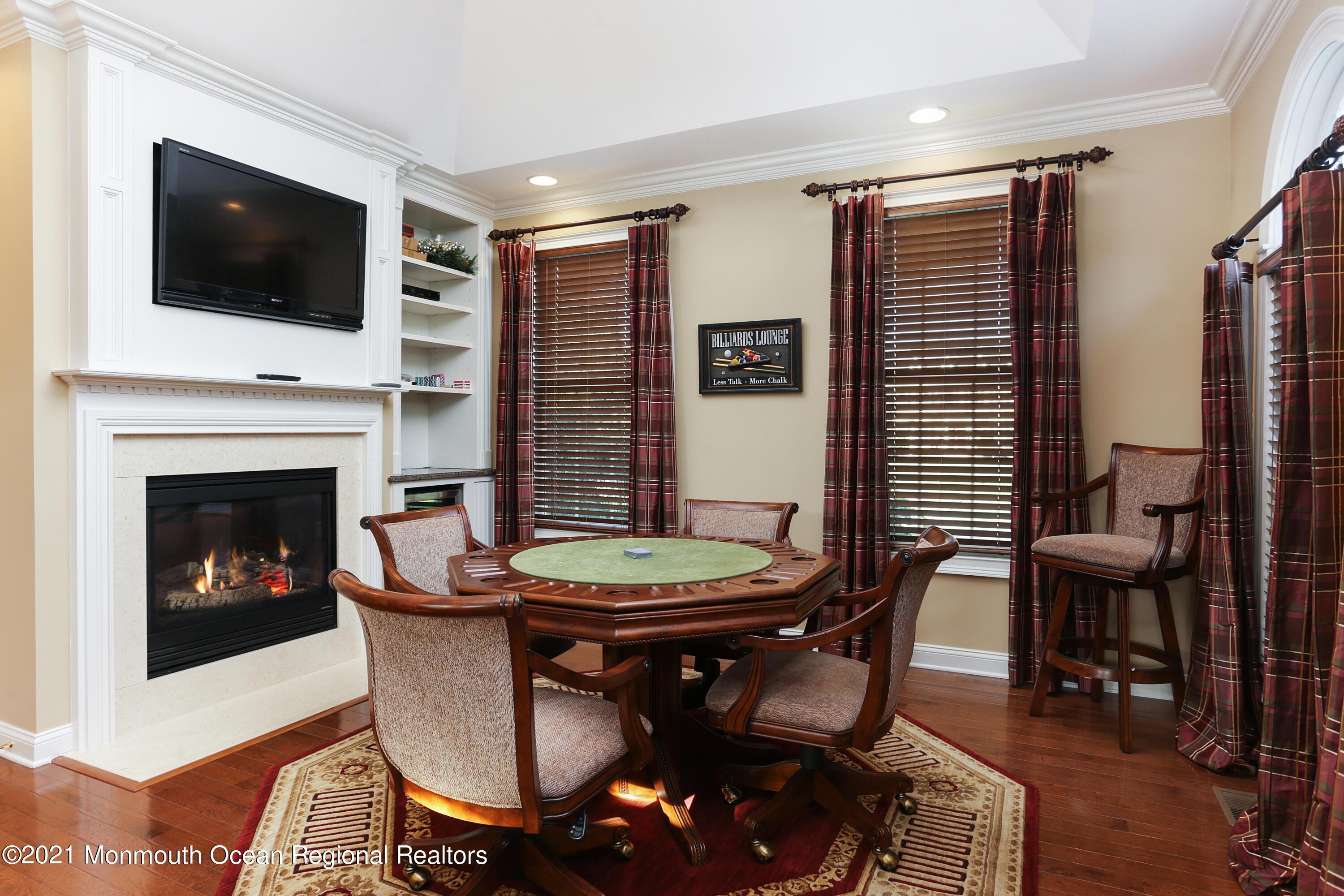 4 Yorktown Road Morganville, NJ 07751 - Photo 11 of 64 a living room with furniture a flat screen tv and a fireplace