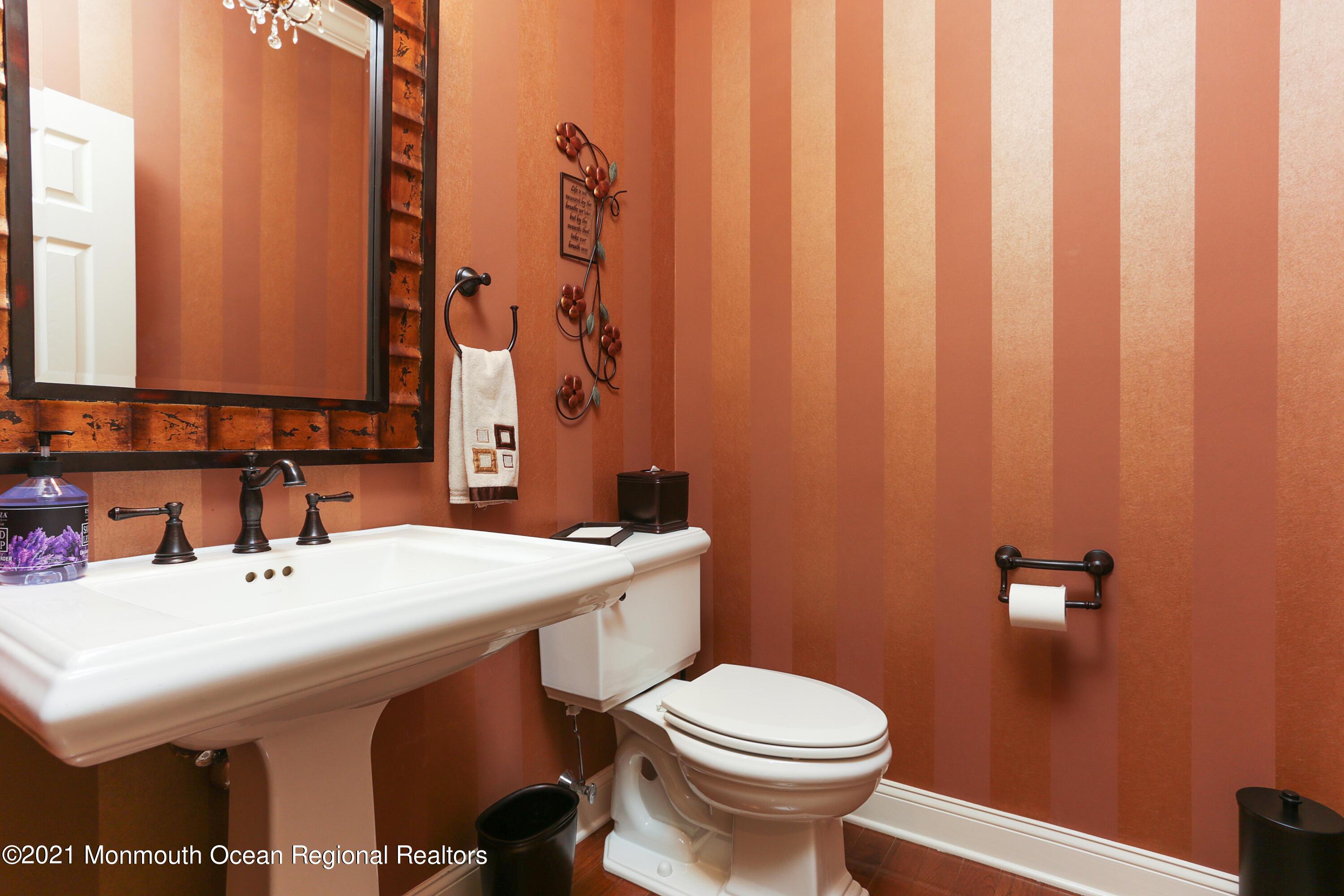 4 Yorktown Road Morganville, NJ 07751 - Photo 12 of 64 a bathroom with a sink a toilet and mirror