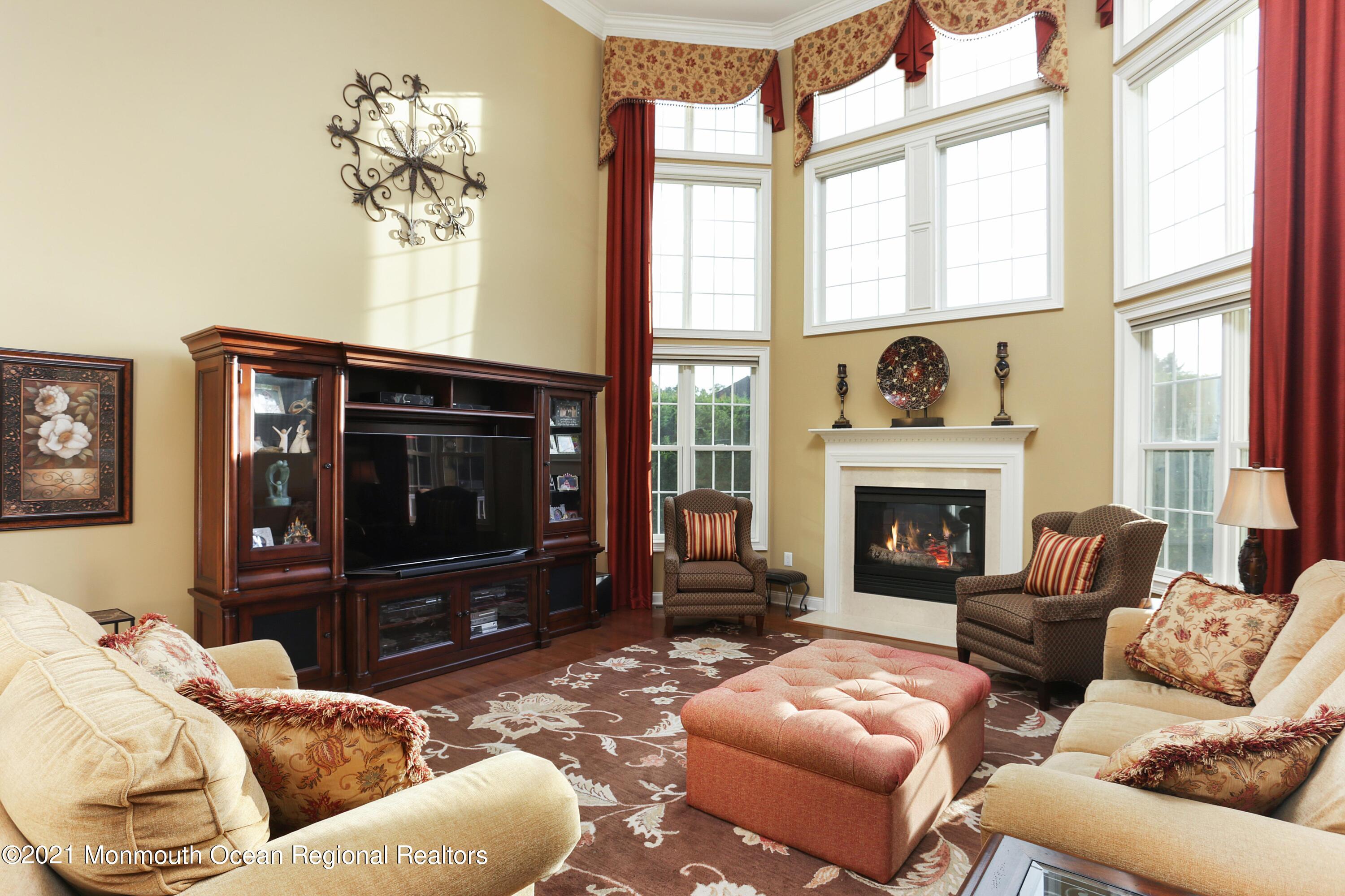 4 Yorktown Road Morganville, NJ 07751 - Photo 15 of 64 a living room with furniture a fireplace and a flat screen tv