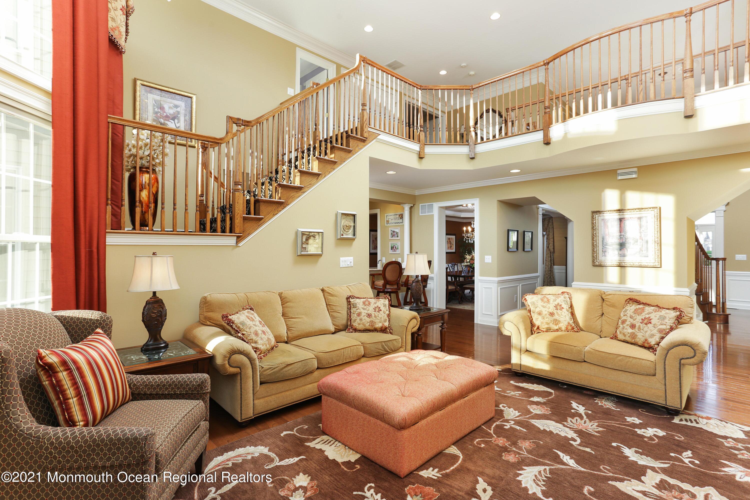 4 Yorktown Road Morganville, NJ 07751 - Photo 16 of 64 a living room with furniture ceiling fan and a rug
