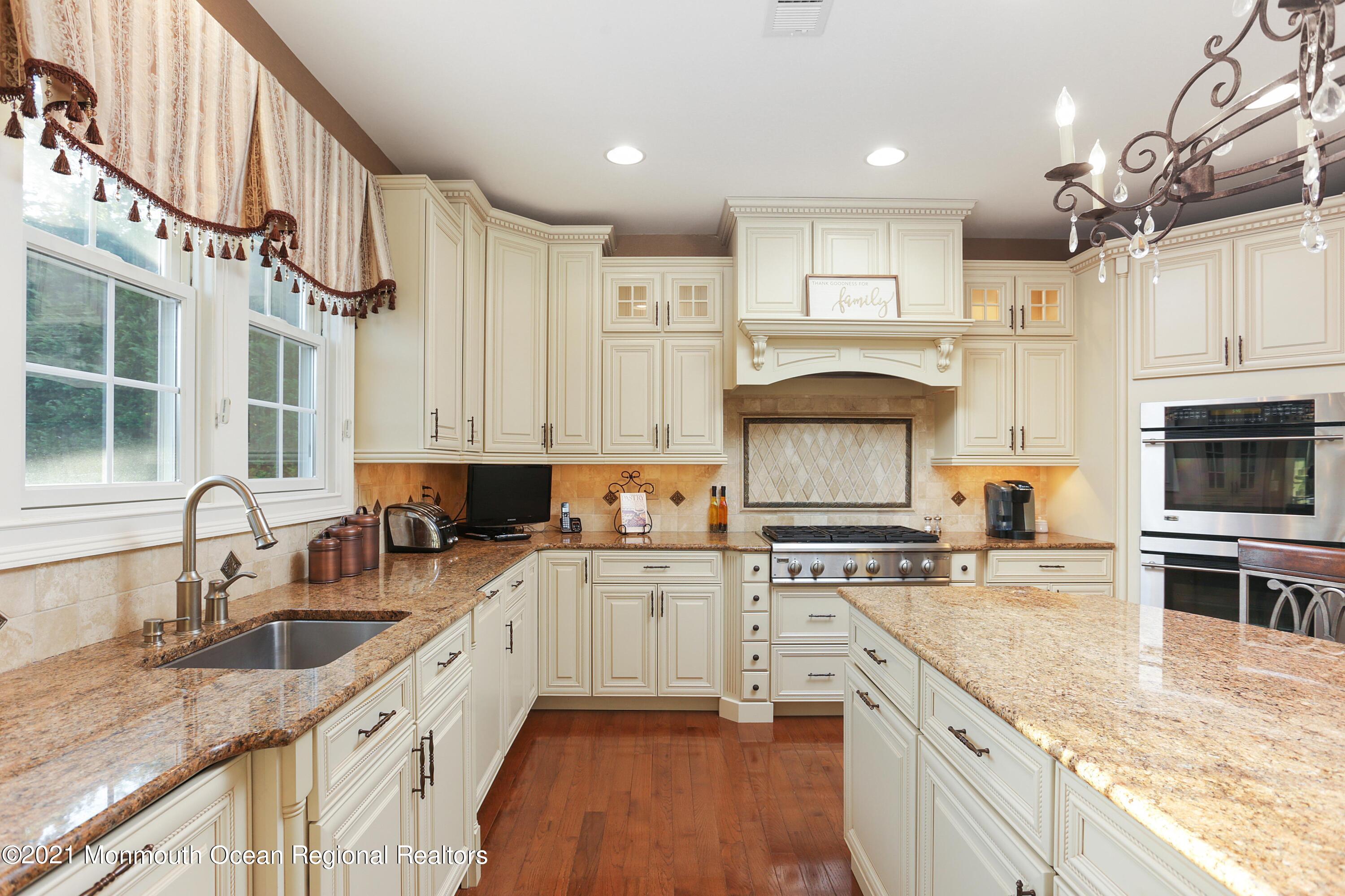 4 Yorktown Road Morganville, NJ 07751 - Photo 19 of 64 a kitchen with stainless steel appliances granite countertop a sink stove and refrigerator