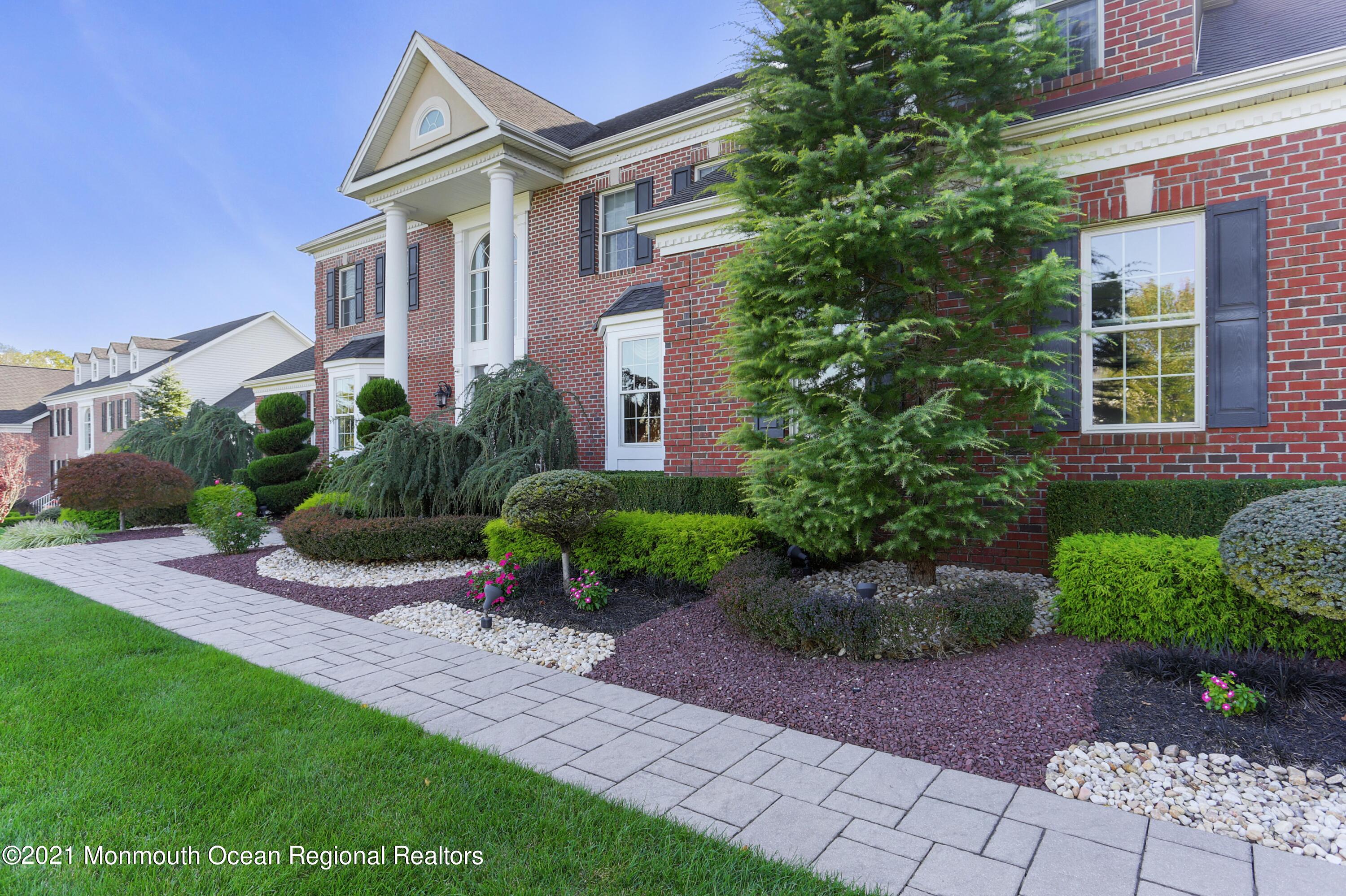 4 Yorktown Road Morganville, NJ 07751 - Photo 3 of 64 a front view of a house with garden