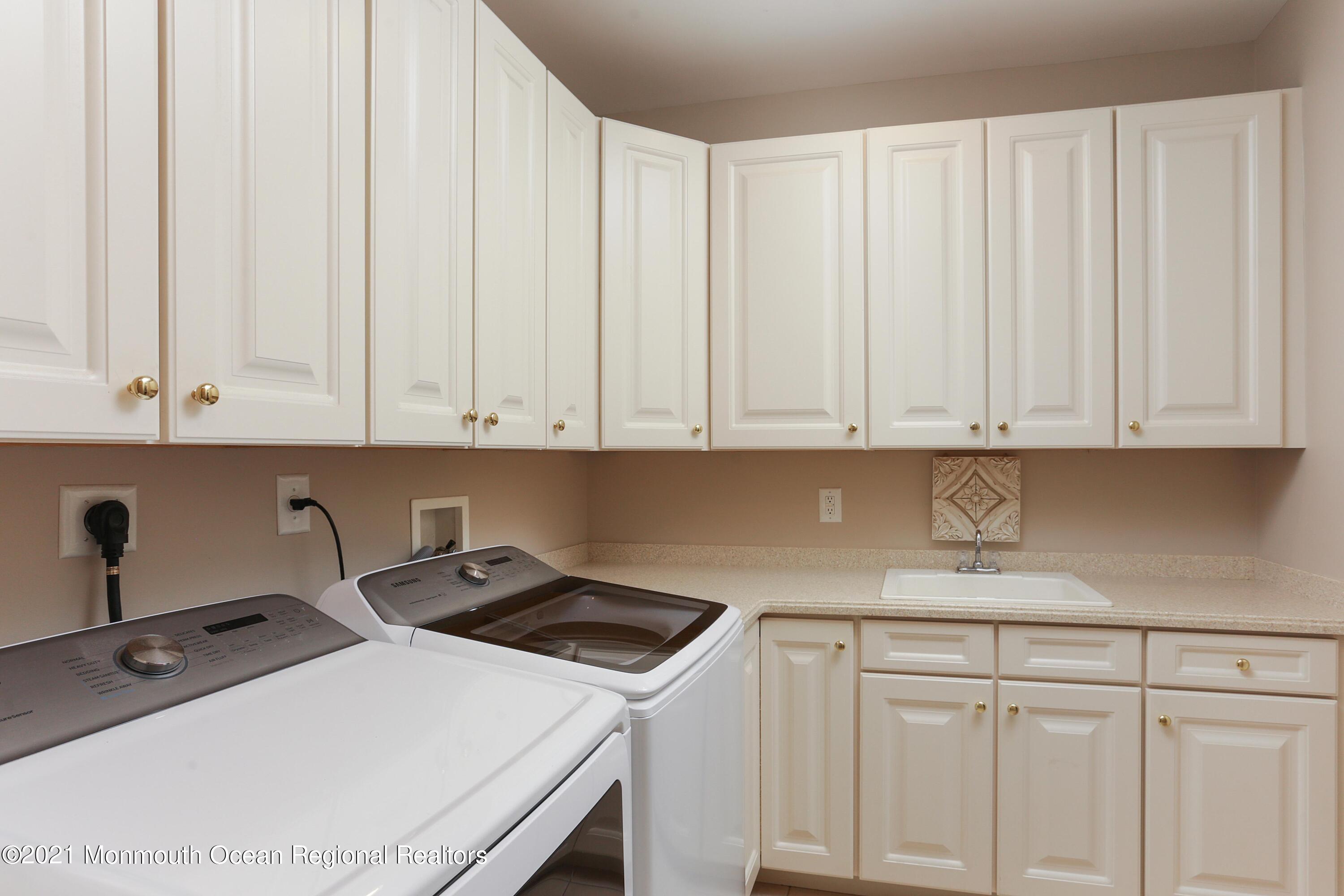 4 Yorktown Road Morganville, NJ 07751 - Photo 23 of 64 a kitchen with white cabinets and sink