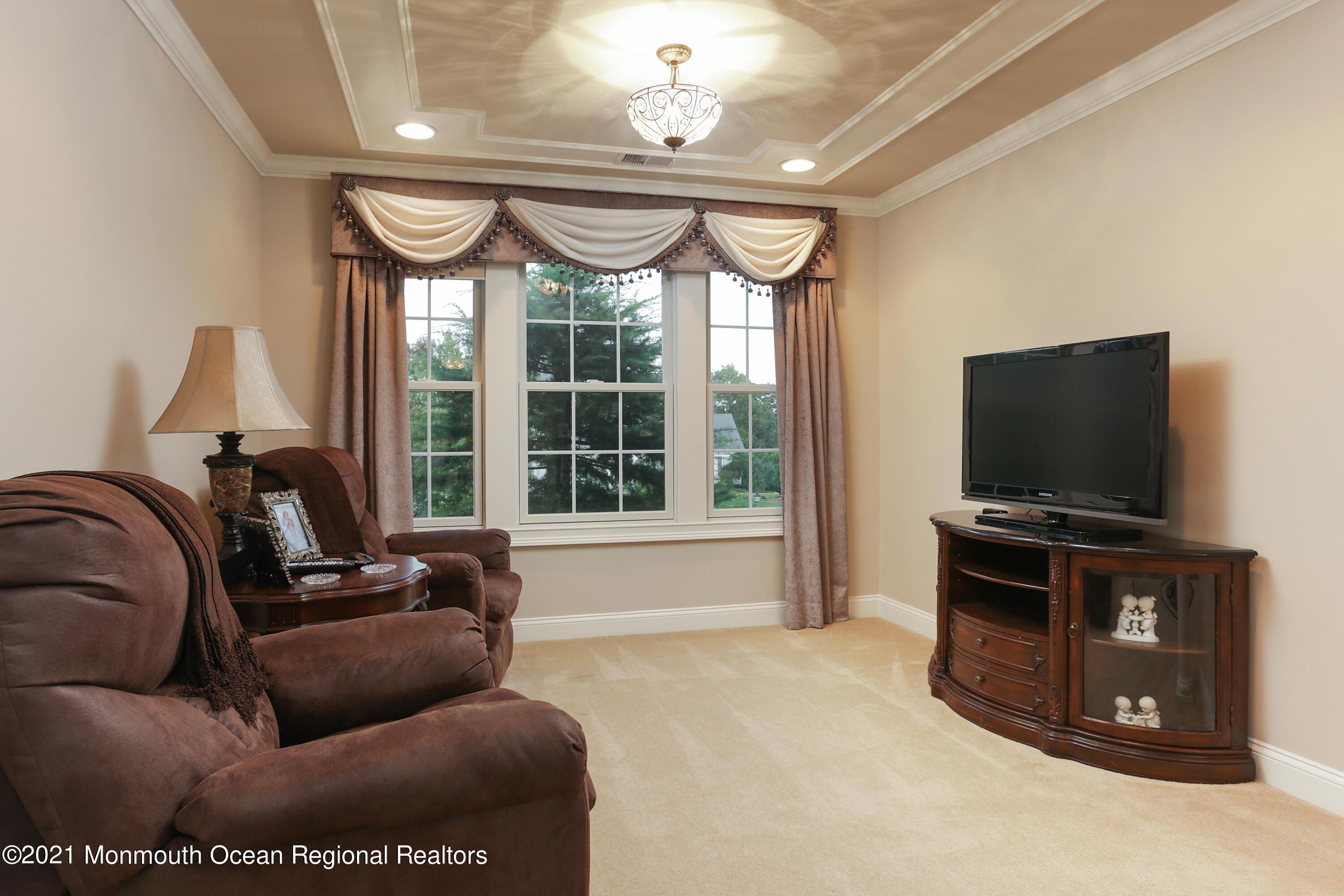 4 Yorktown Road Morganville, NJ 07751 - Photo 27 of 64 a living room with furniture and a flat screen tv