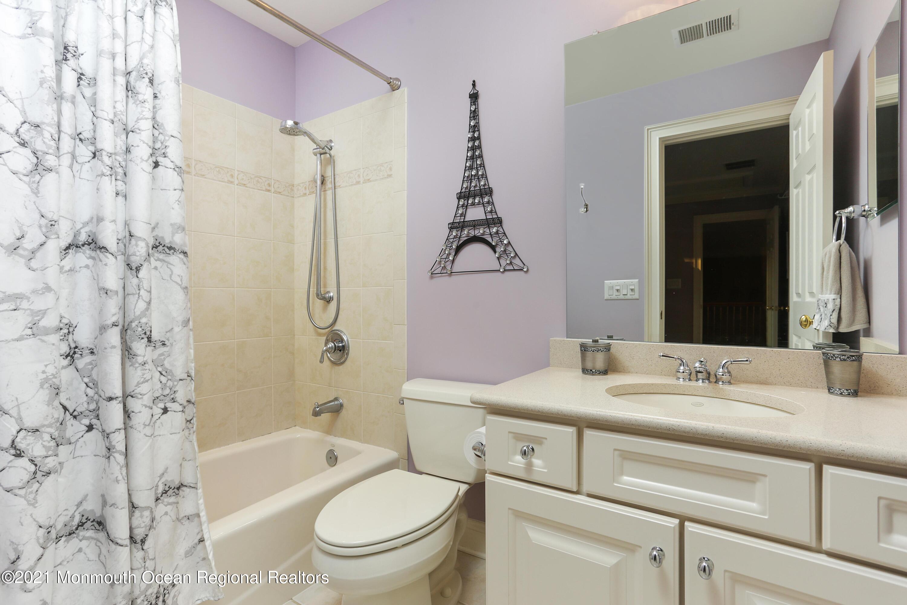 4 Yorktown Road Morganville, NJ 07751 - Photo 31 of 64 a bathroom with a granite countertop sink toilet mirror vanity and bathtub