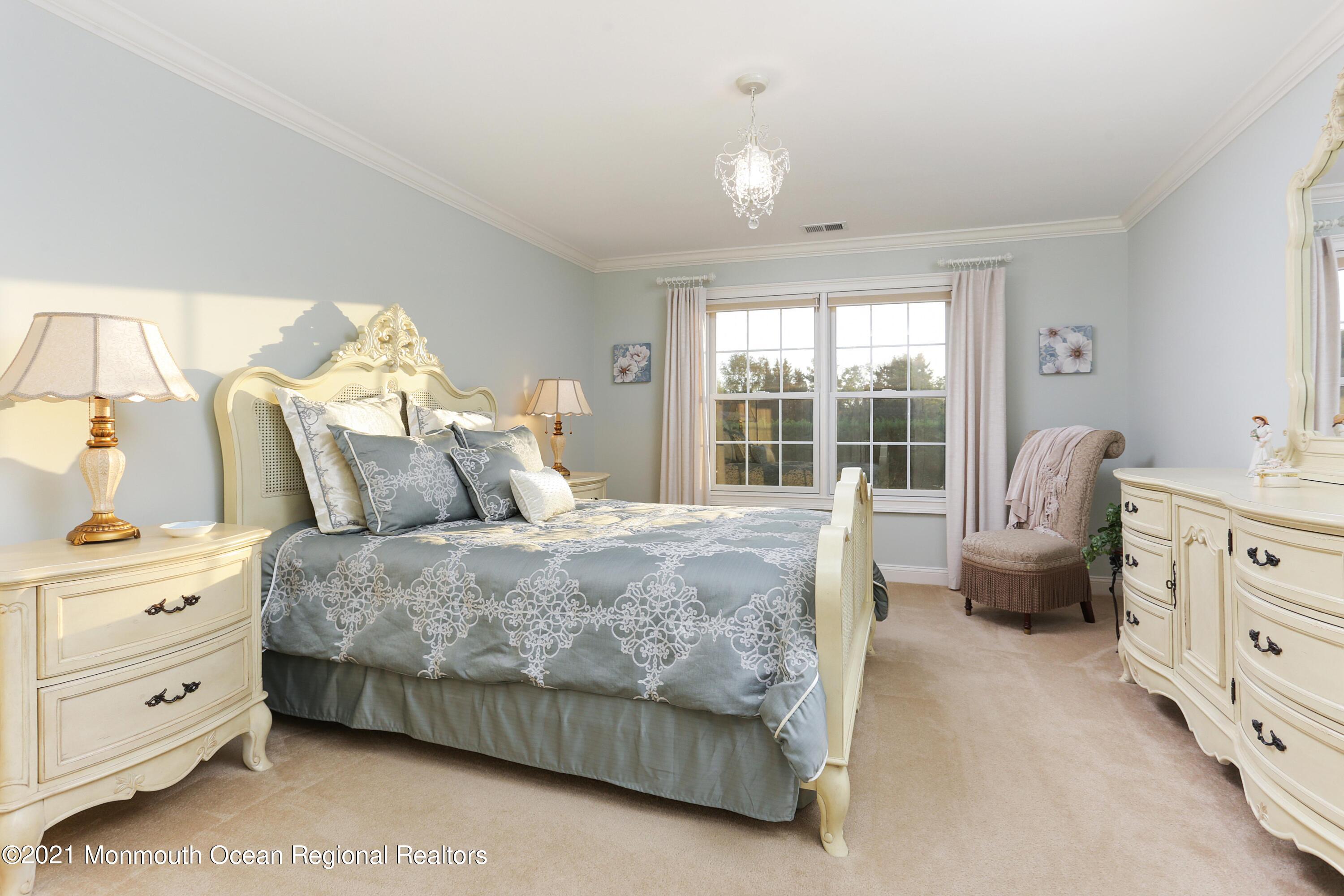 4 Yorktown Road Morganville, NJ 07751 - Photo 32 of 64 a spacious bedroom with a bed and a couch