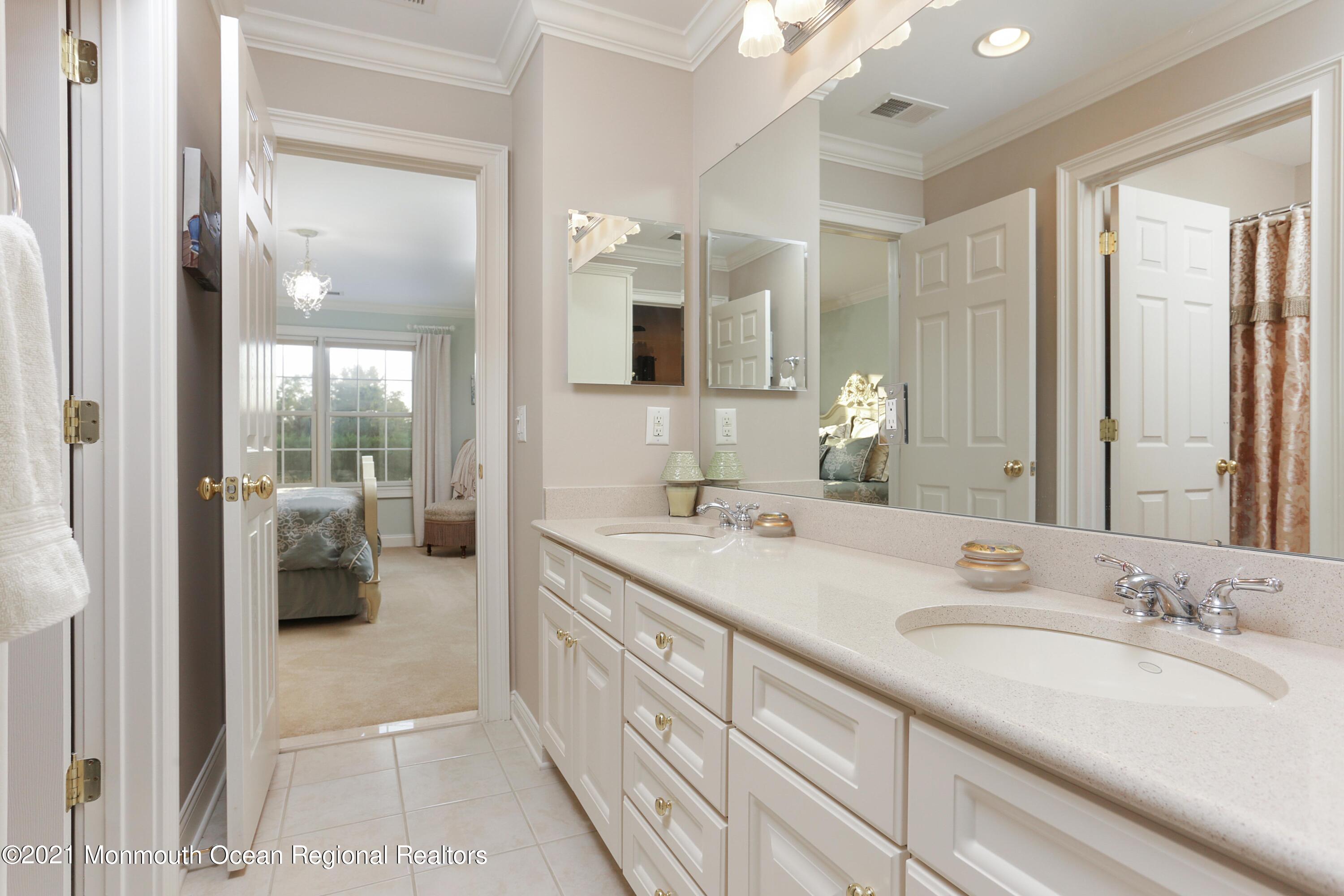 4 Yorktown Road Morganville, NJ 07751 - Photo 33 of 64 a spacious en suite bathroom with a granite countertop sink mirror and shower