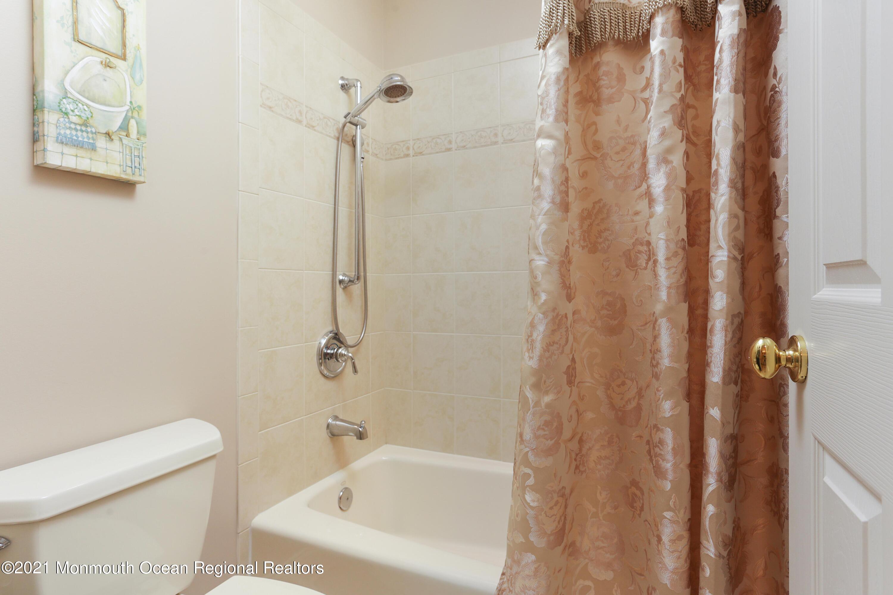 4 Yorktown Road Morganville, NJ 07751 - Photo 34 of 64 a bathroom with a bathtub and shower
