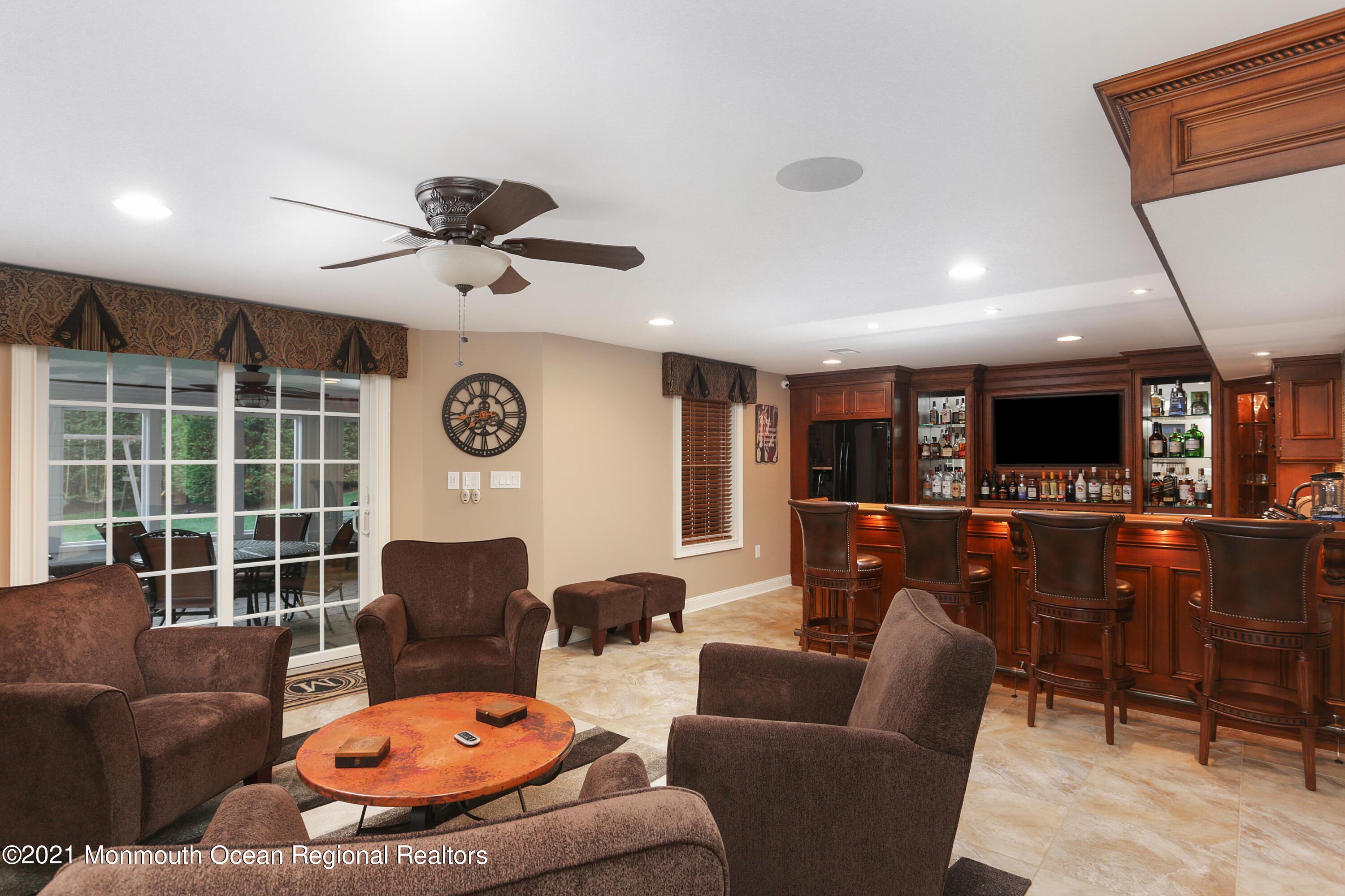4 Yorktown Road Morganville, NJ 07751 - Photo 37 of 64 a living room with furniture a ceiling fan and a window
